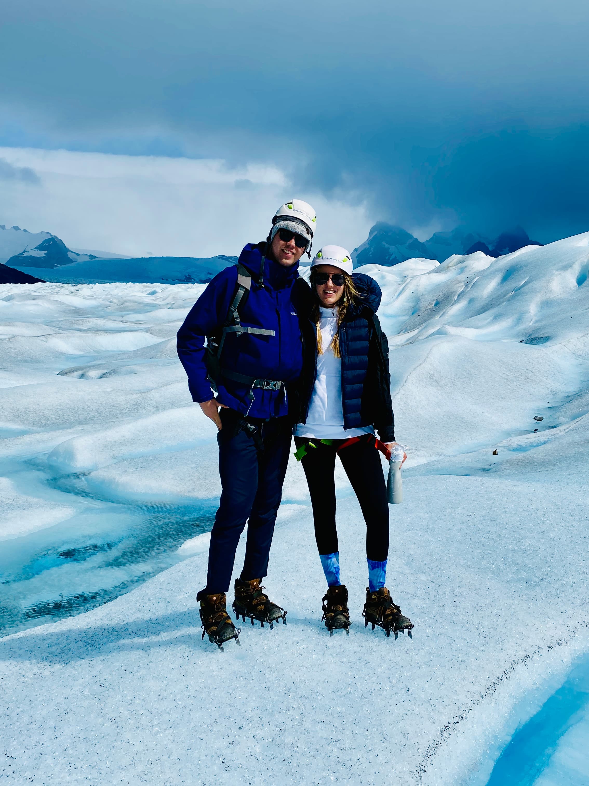 Advisor and partner in winter clothing posing side by side in an arctic landscape covered in snow