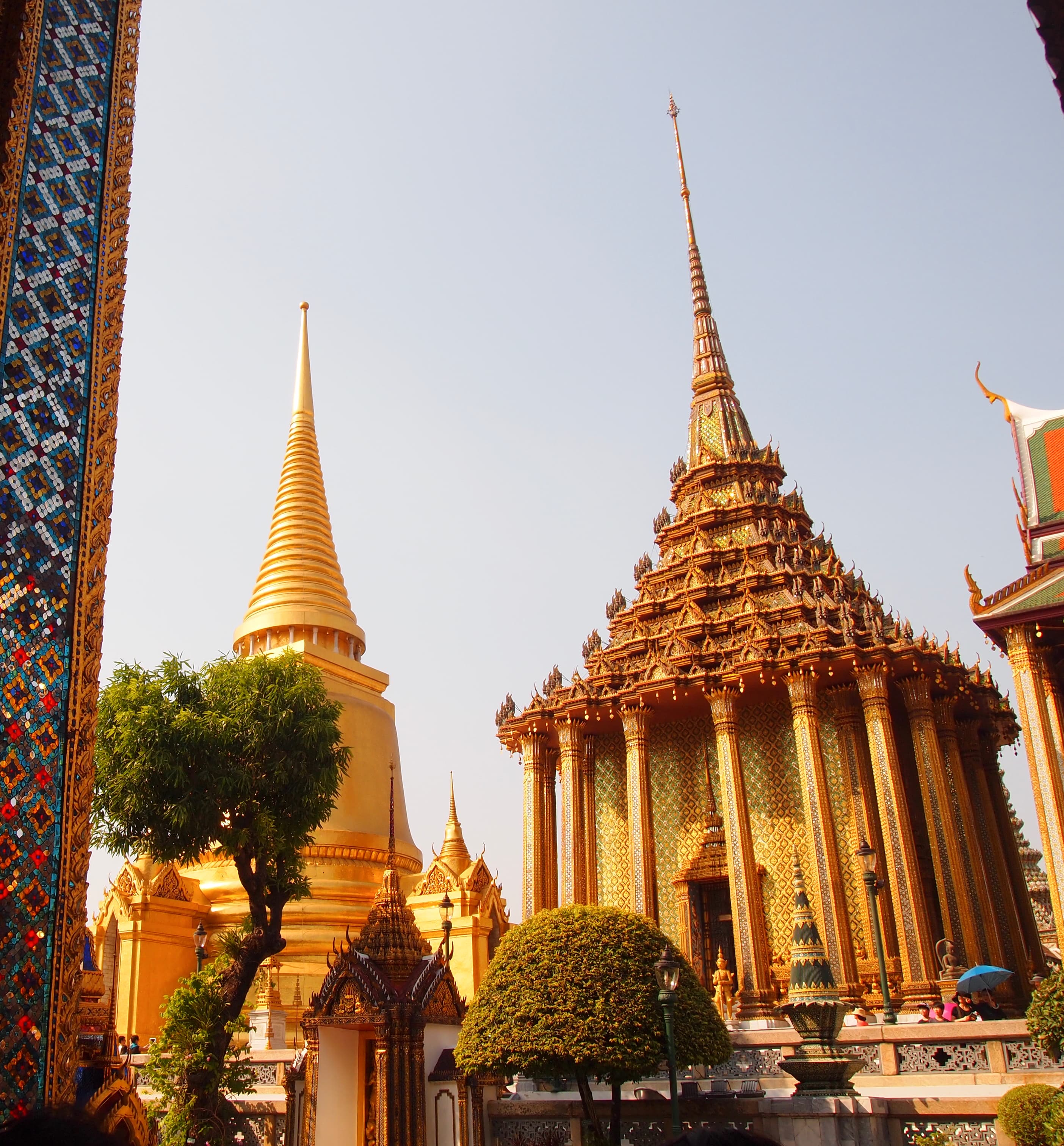 View of a beautifully ornate golden temple complex on a clear day