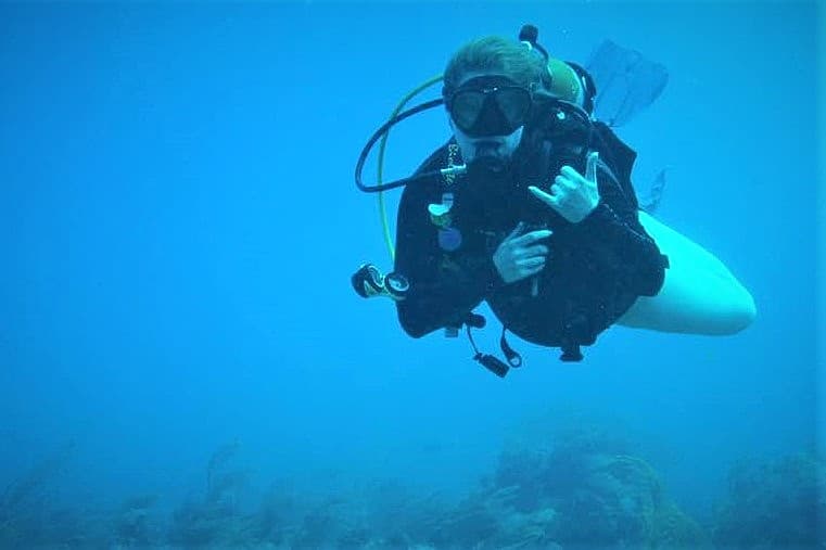 View of advisor underwater in scuba diving gear