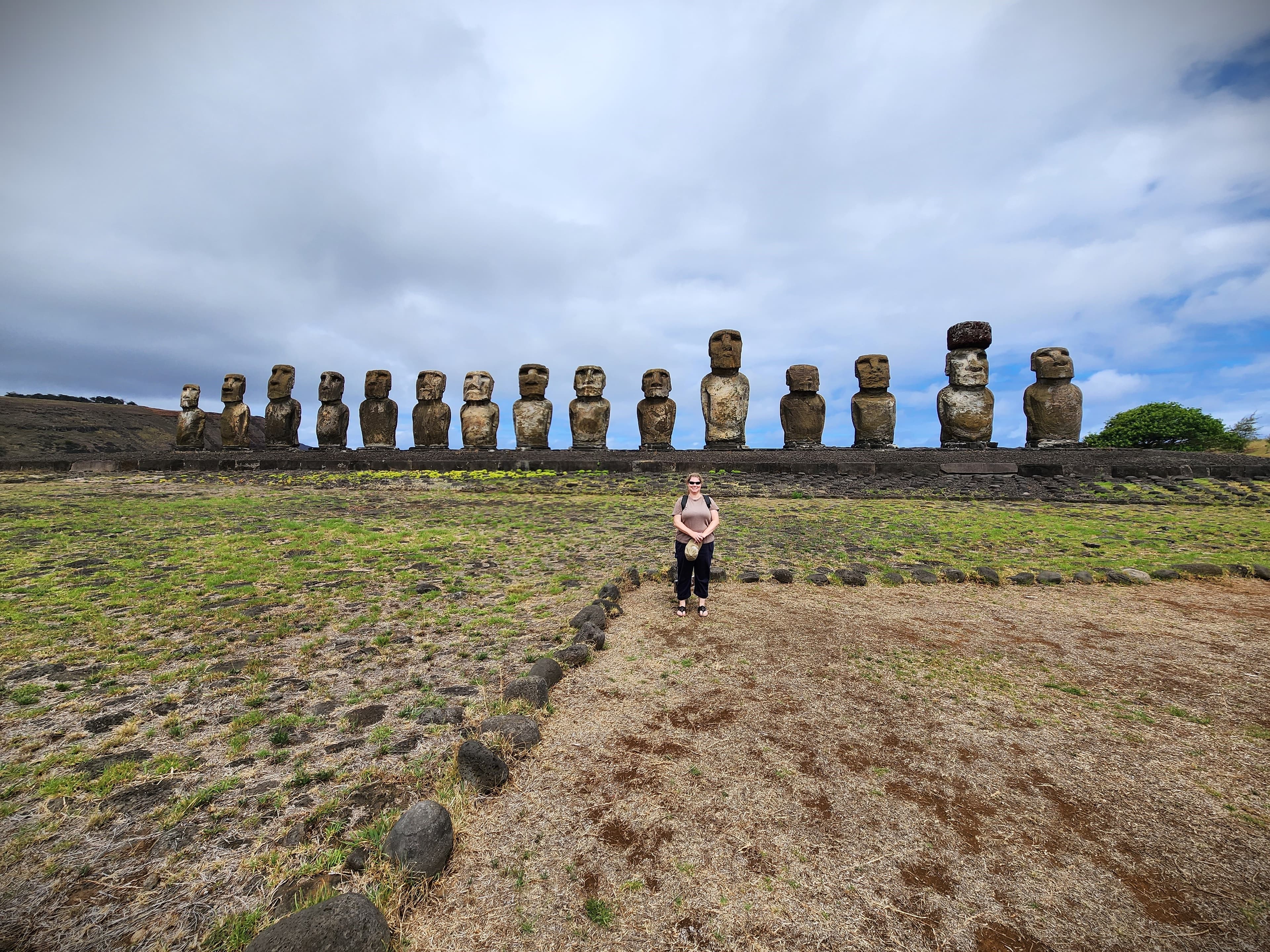 Advisor in a field with Easter Island statues in a line behind her