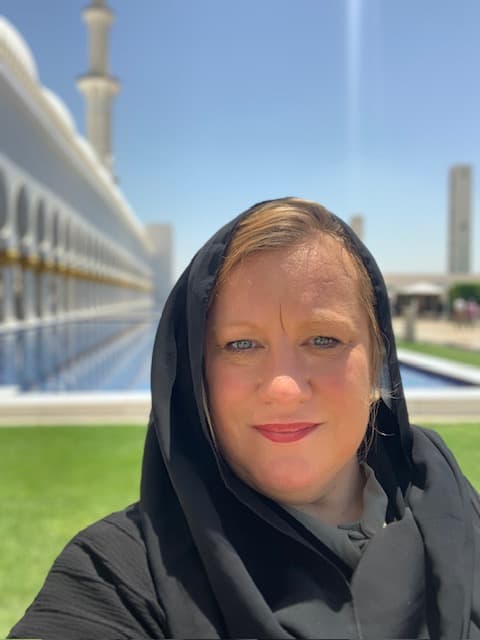 Advisor with a head scarf covering taking a selfie outdoors on a sunny day