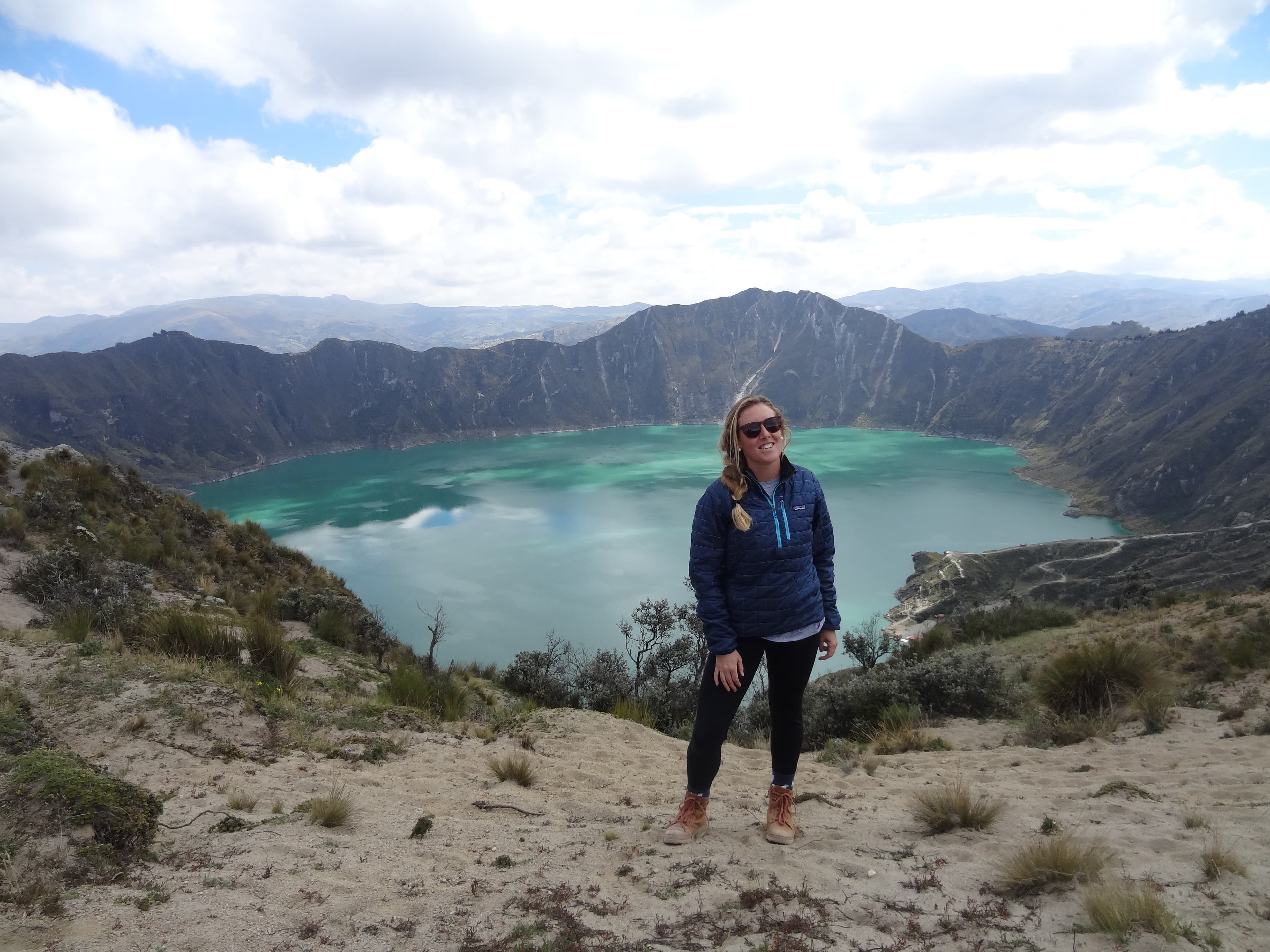 Advisor on a hike with a beautiful glacial lake and mountain vista in the background