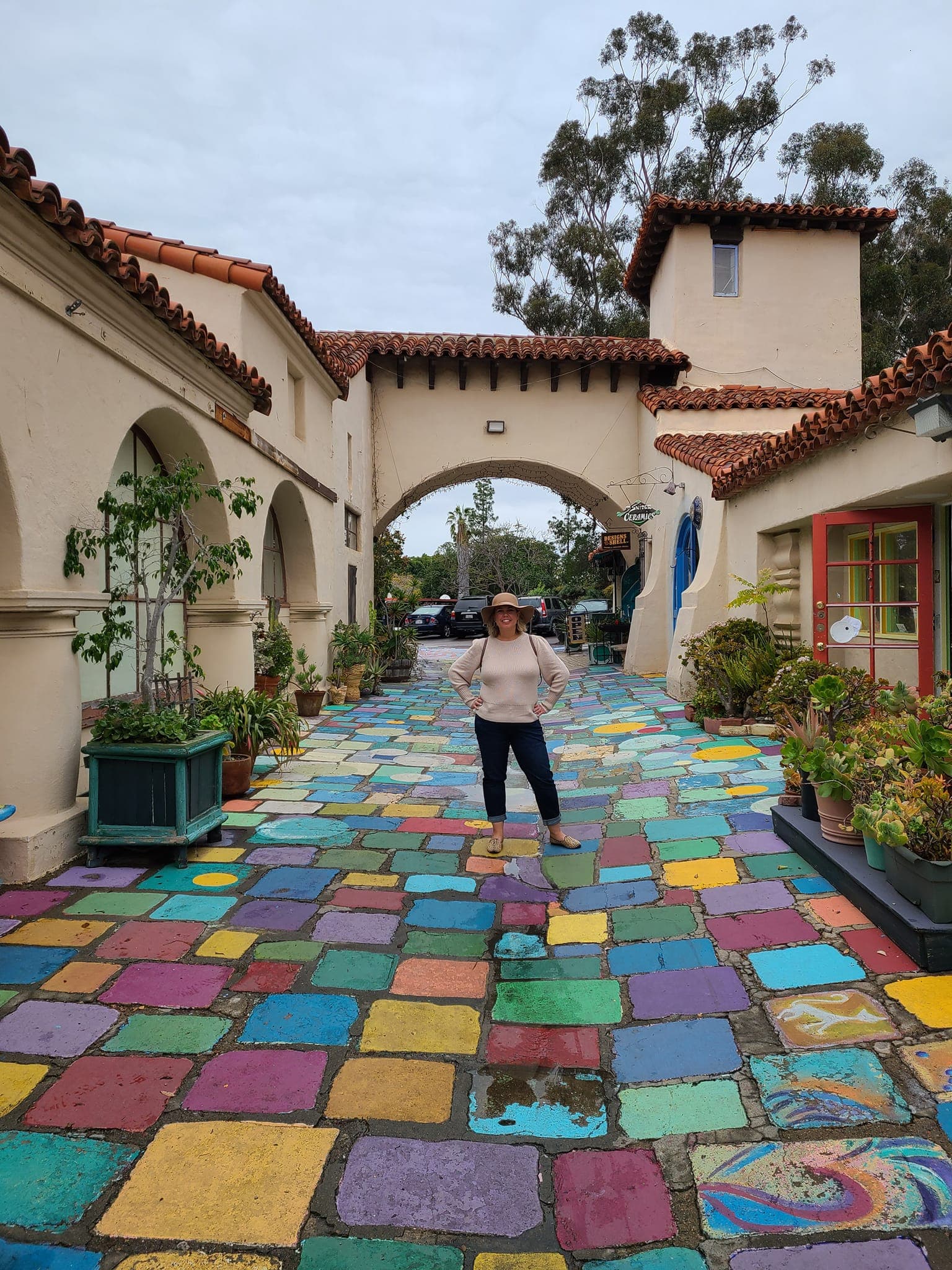 View of advisor standing on a colorfully tiled street in San Diego on a cloudy day