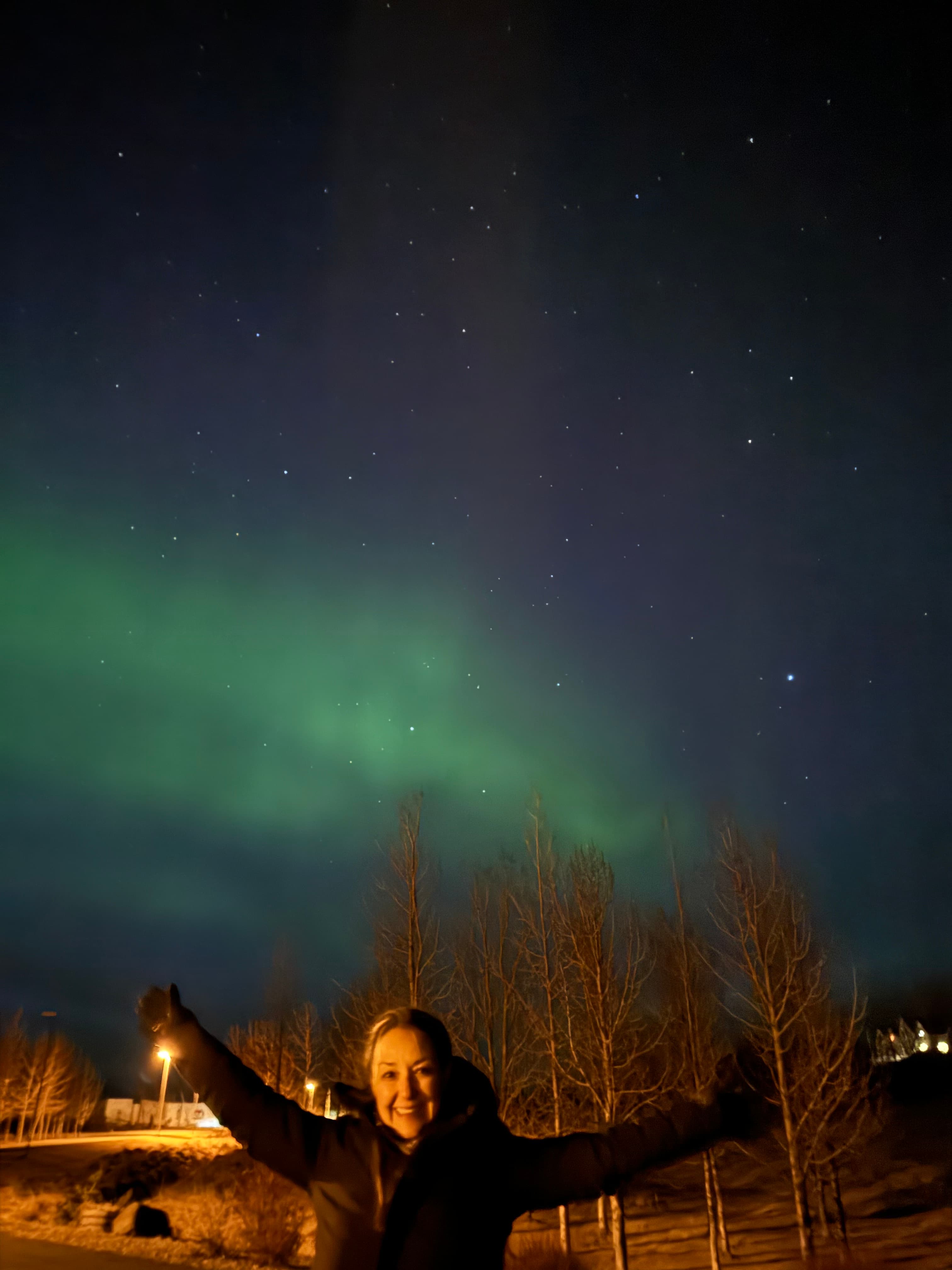 Karla posing in front of the Northern Lights.