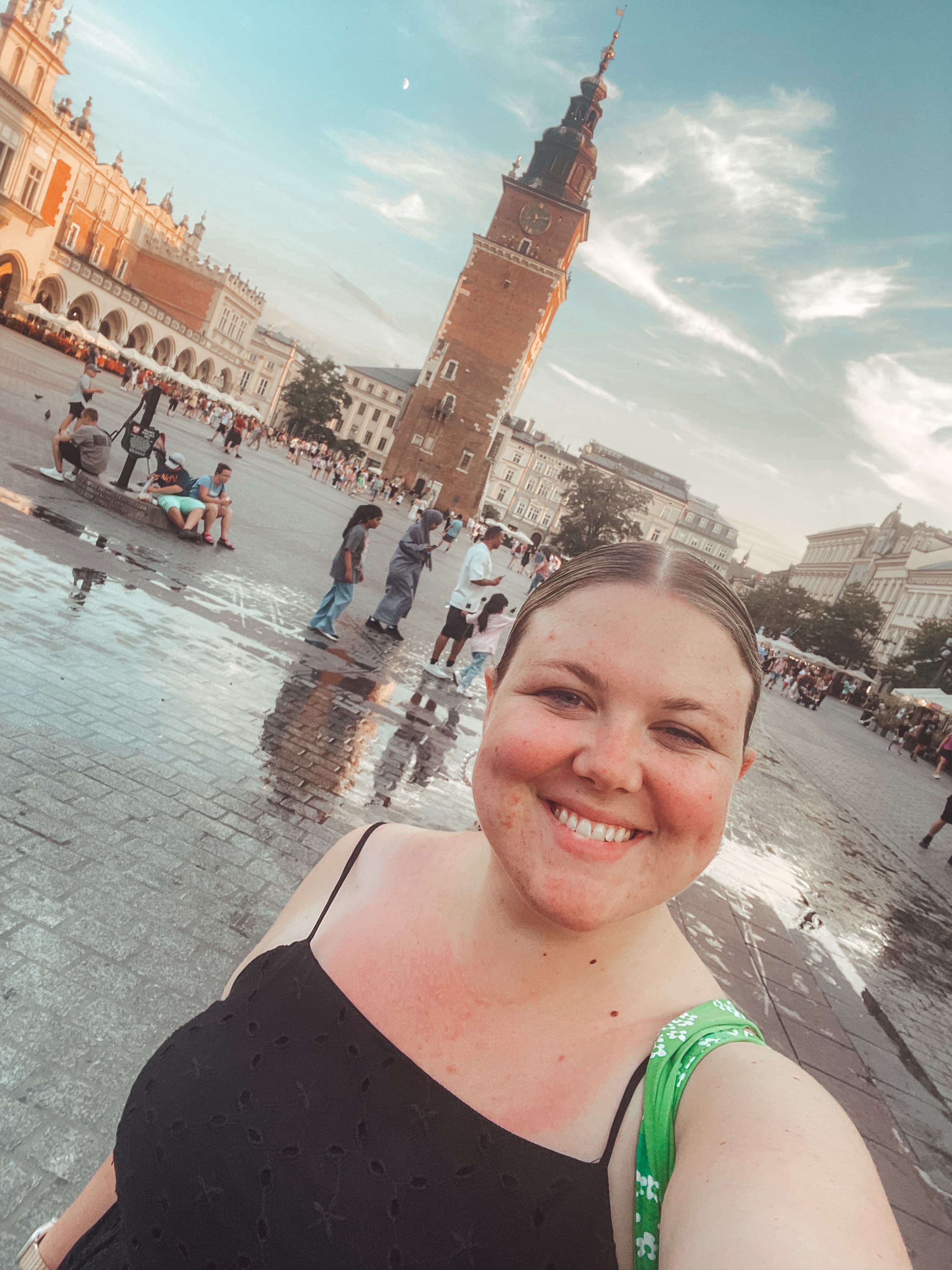 Emily taking a selfie in St. Marks square in Venice on a sunny day