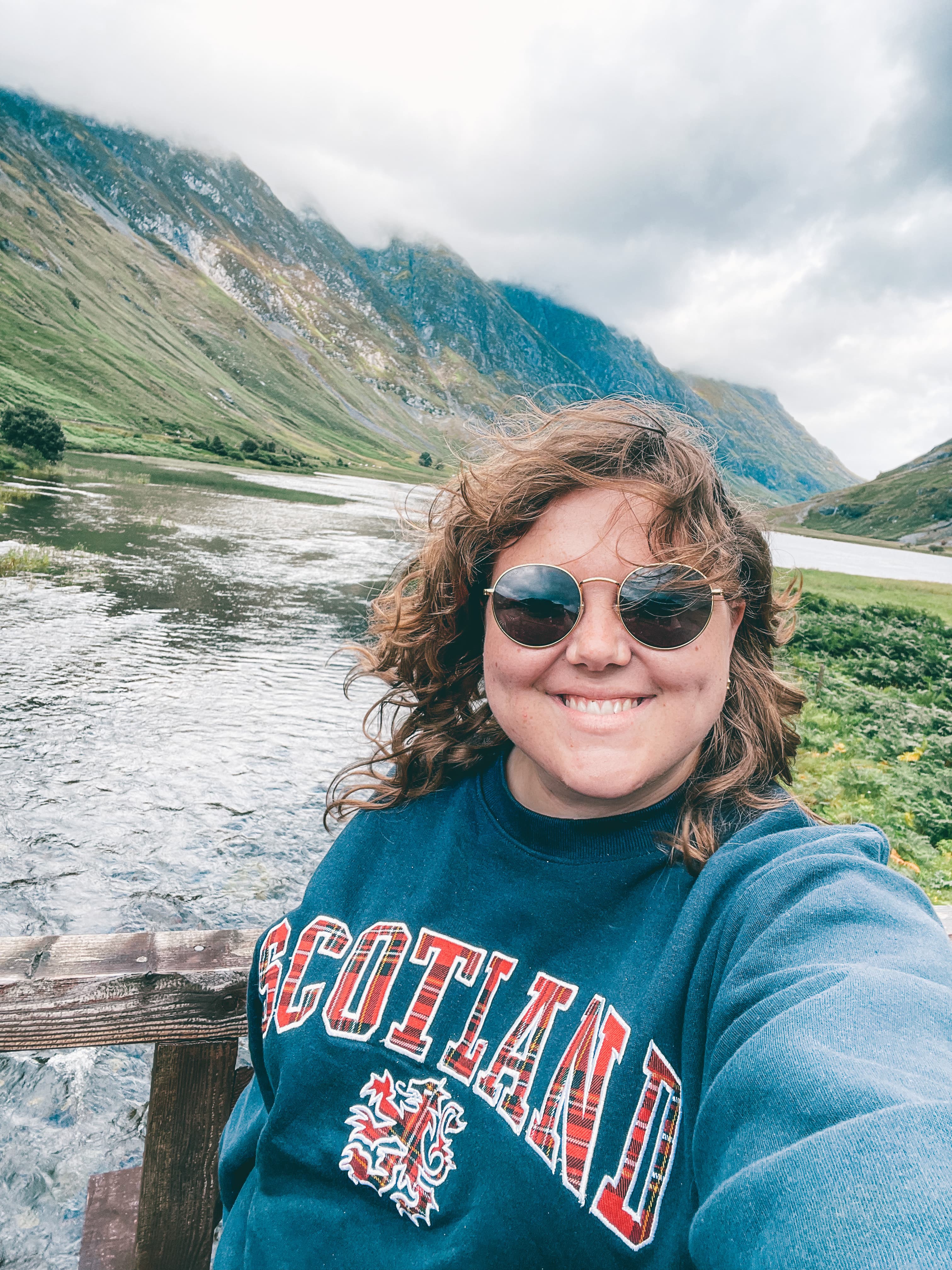 Advisor taking a selfie in a beautiful valley on a cloudy day