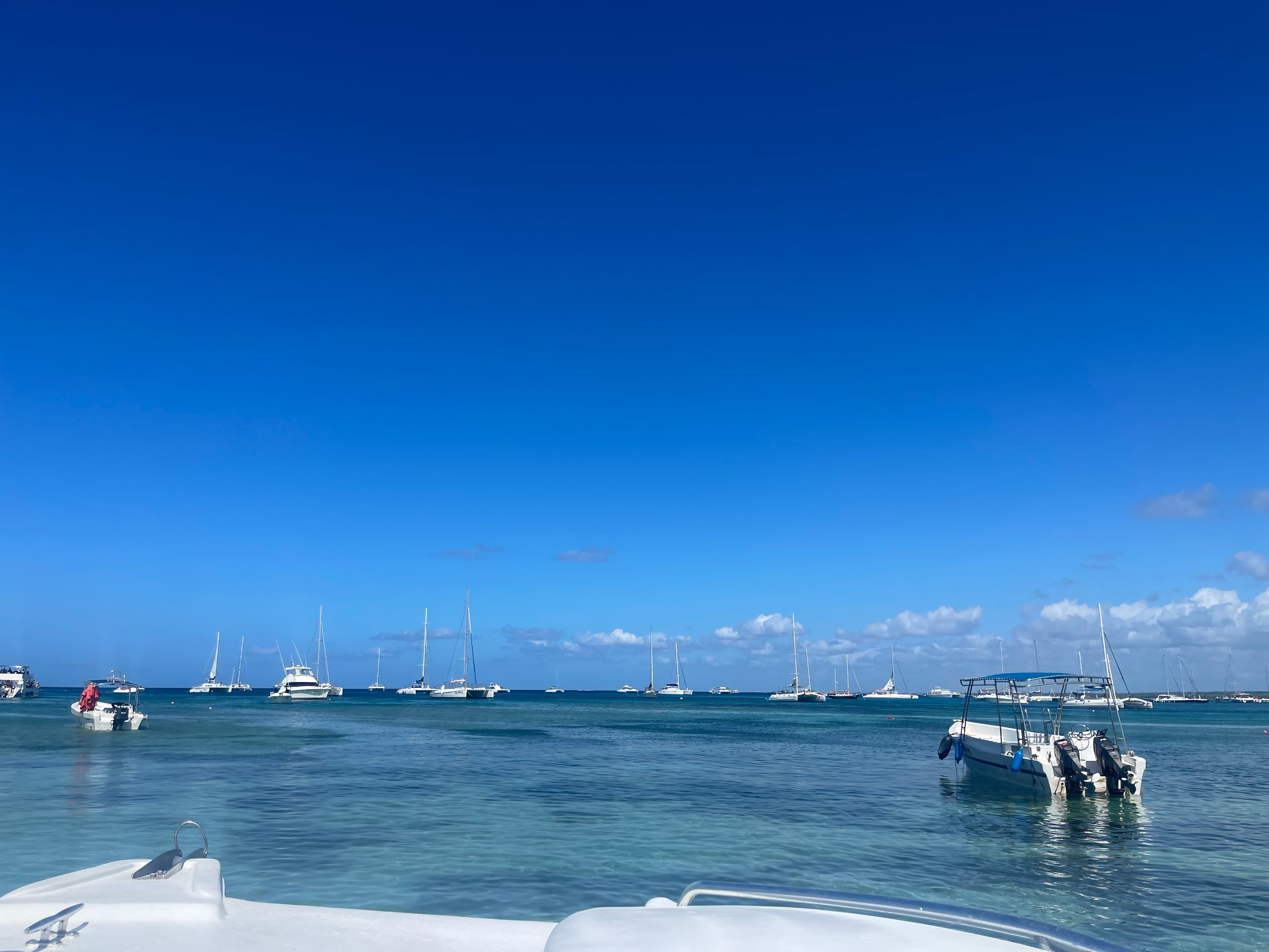 View of the ocean with a few boats in it during the daytime.