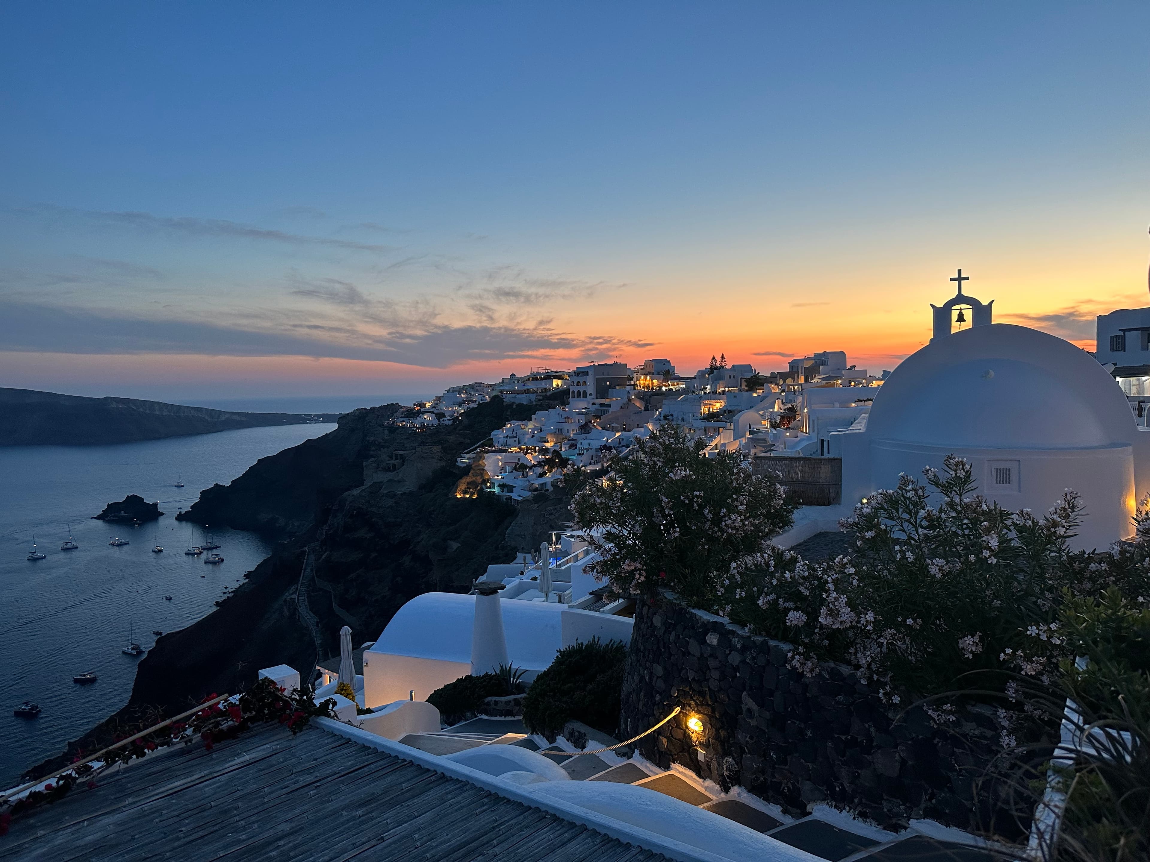 An aerial view of a coastal city at dusk.