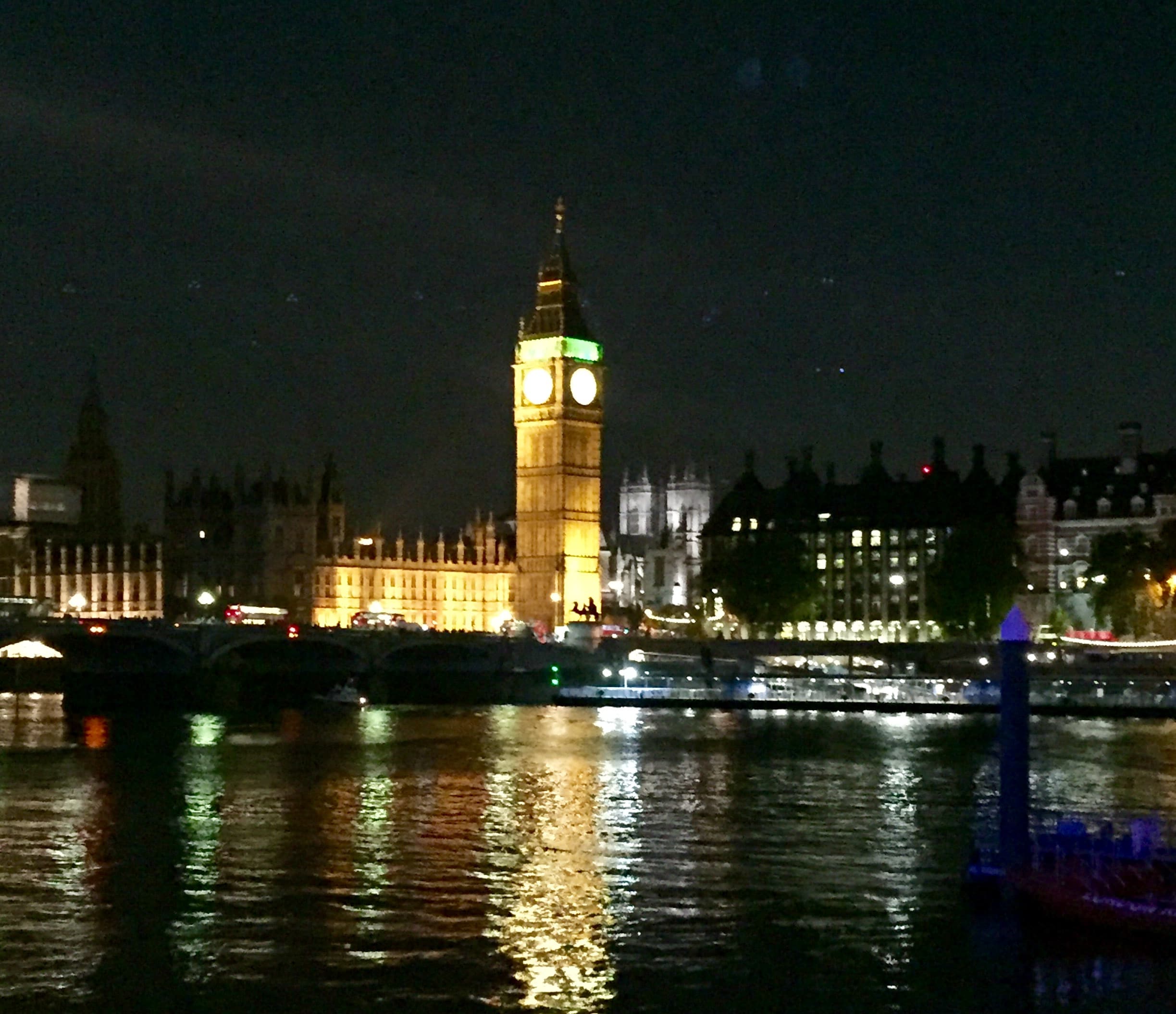 View of London’s Big Ben lit up at night as seen from across the Thames