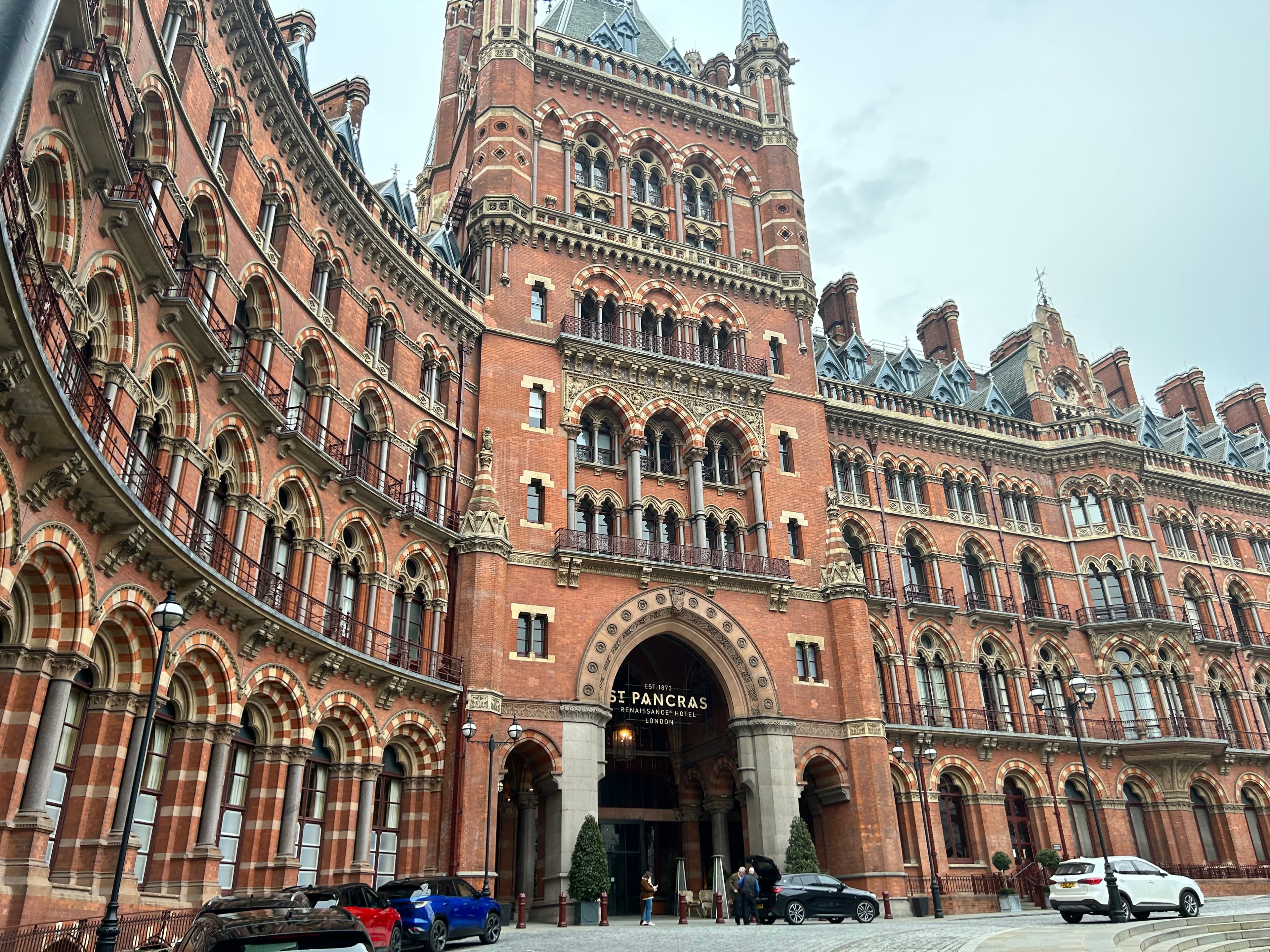 View of a large brick building with many windows on a cloudy day