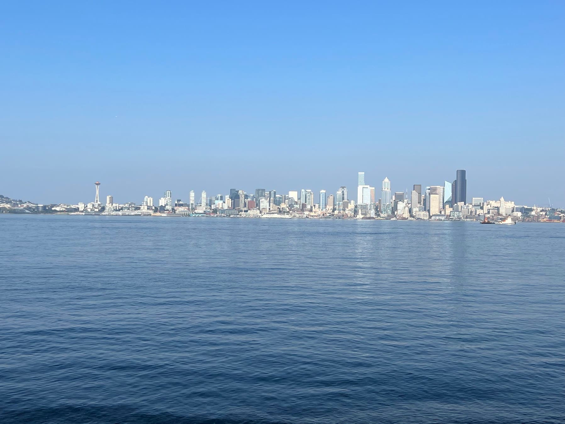 A cityscape against a body of water.