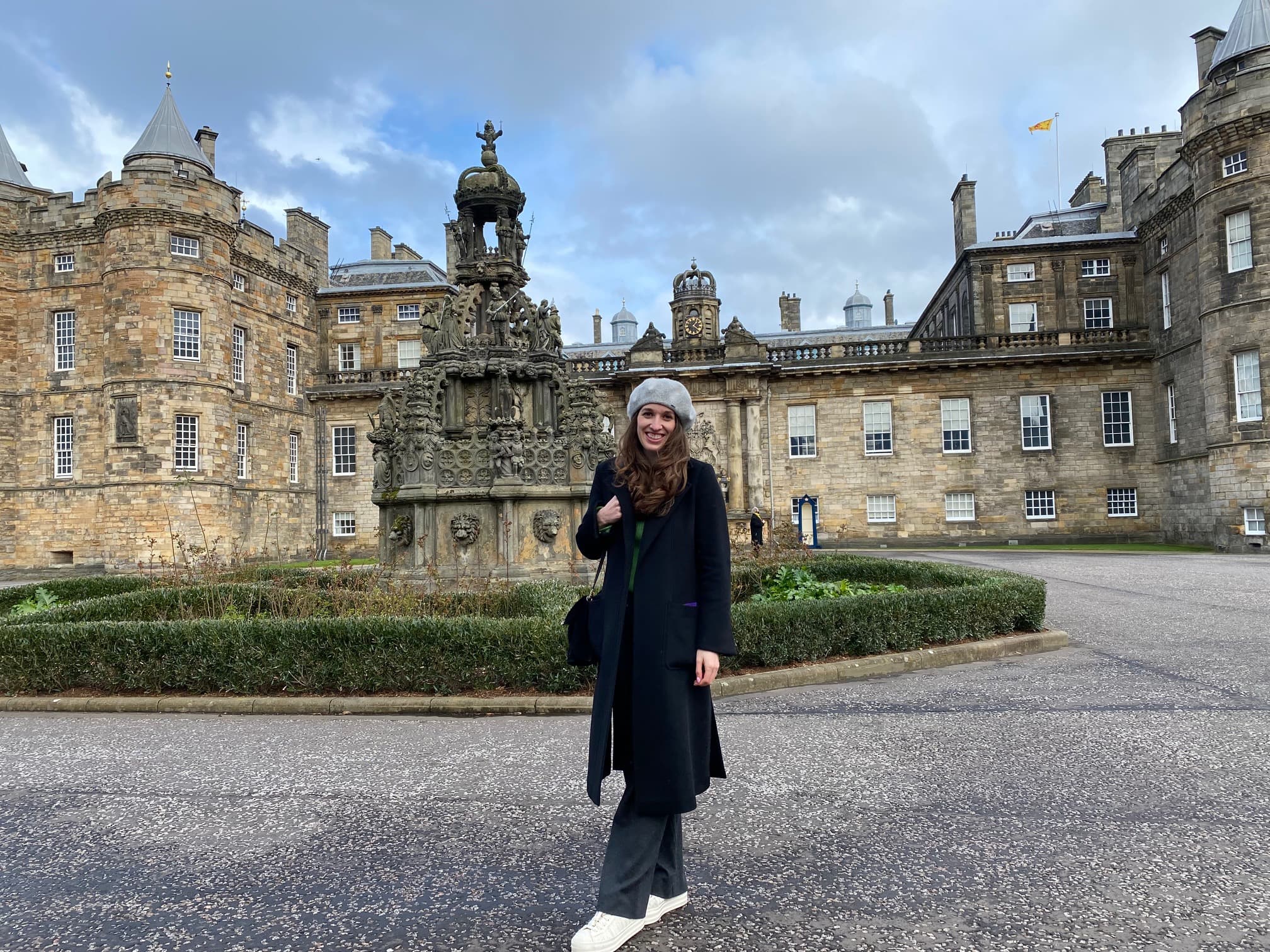 Advisor posing for an image with classic buildings in the distance.
