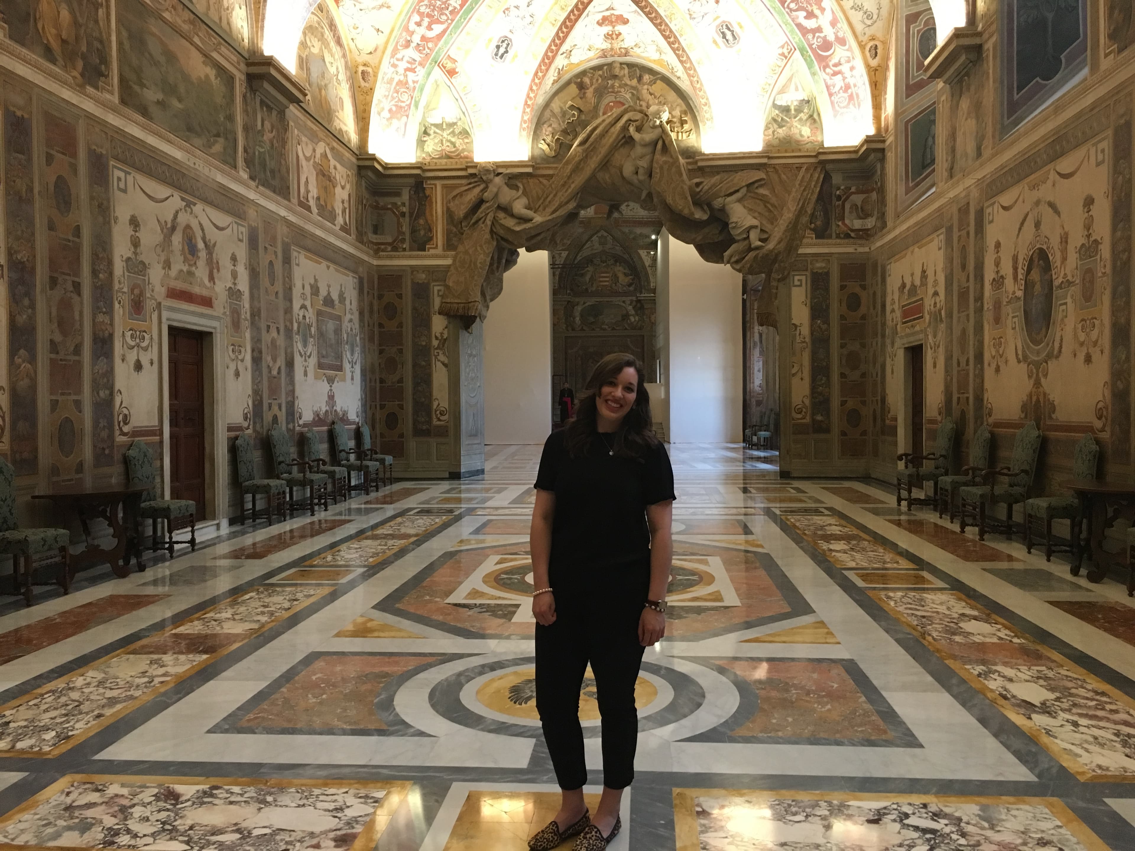 Advisor posing for an image in a classic building.