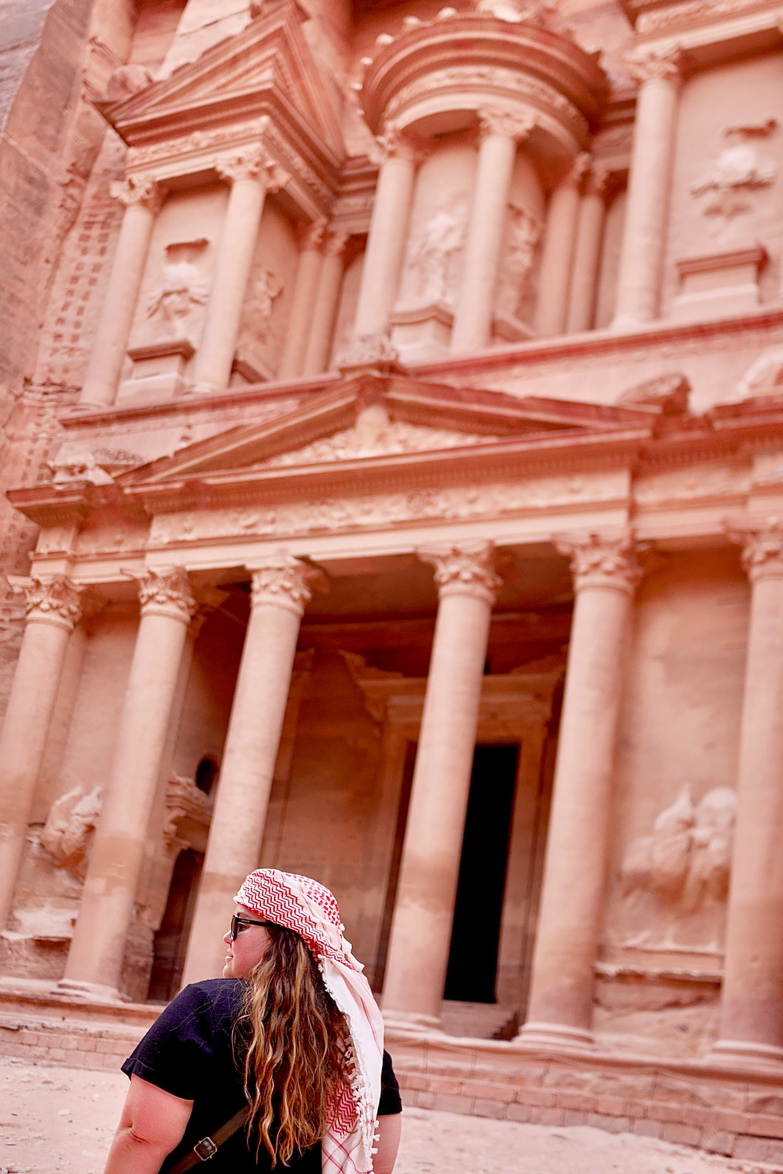 Advisor standing in front of a pink facade.