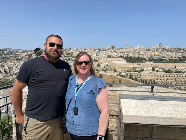 Jenni and friend posing on a rooftop during the daytime.