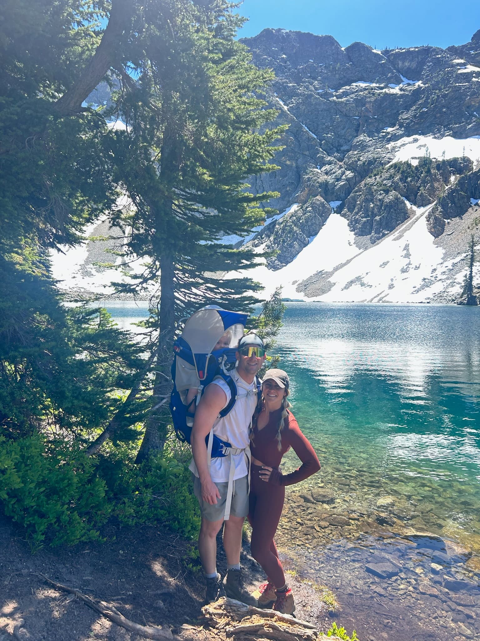 Advisor posing near mountain lake on a sunny day.
