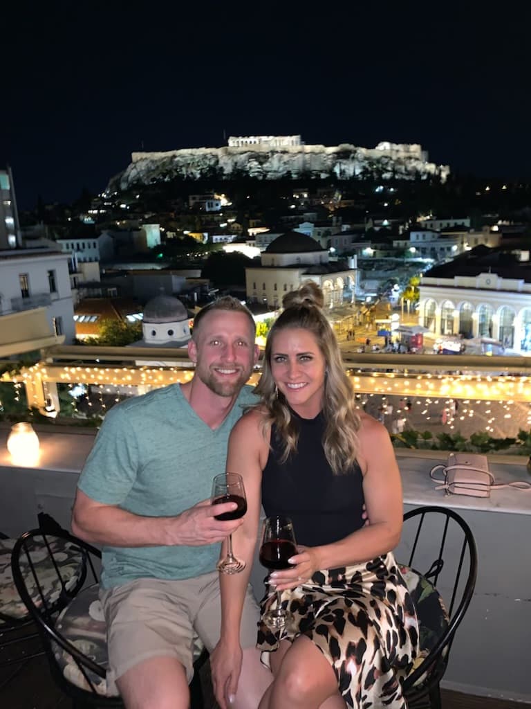 Advisor posing on a rooftop in the evening.