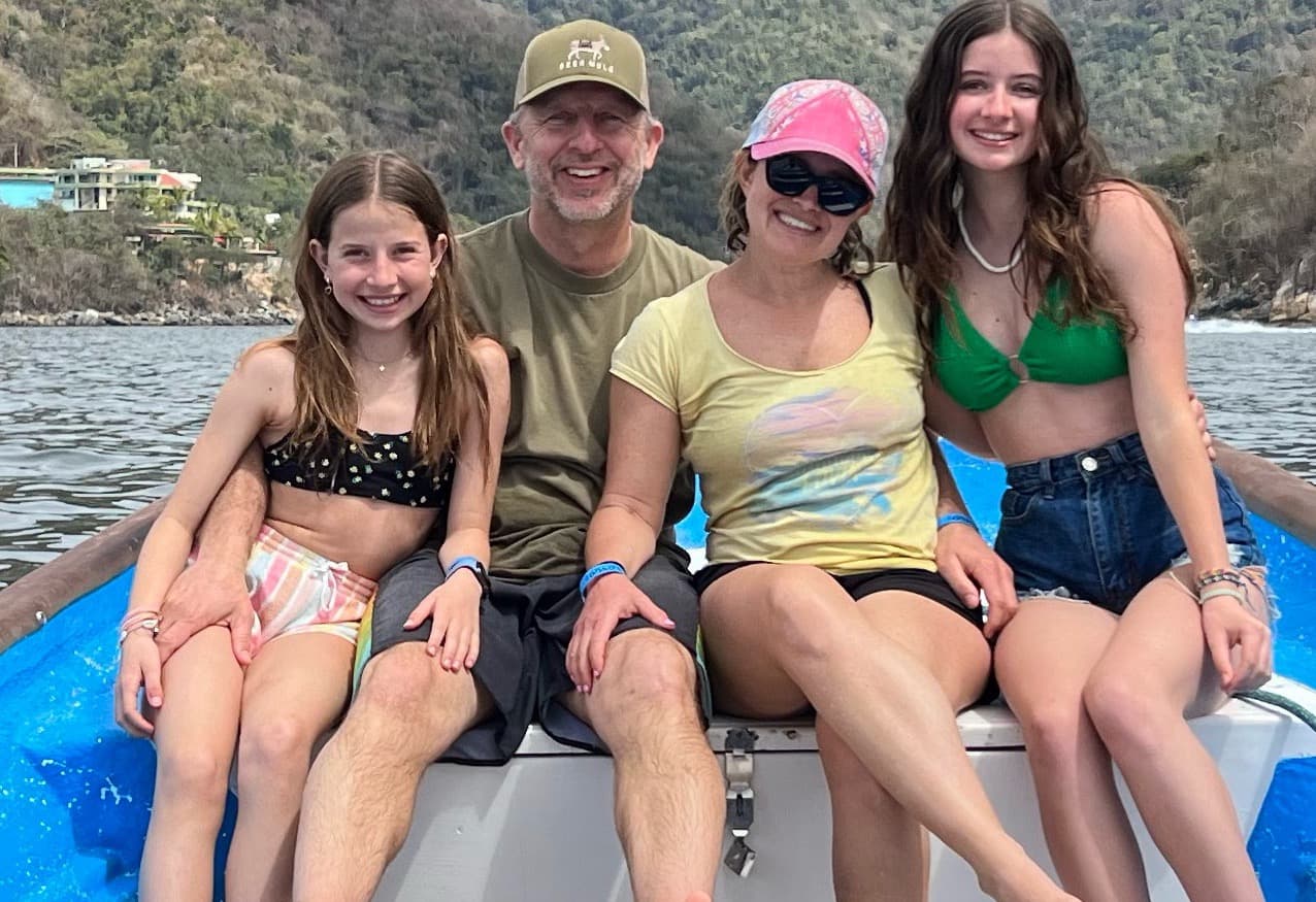 Advisor and family on a boat during the day