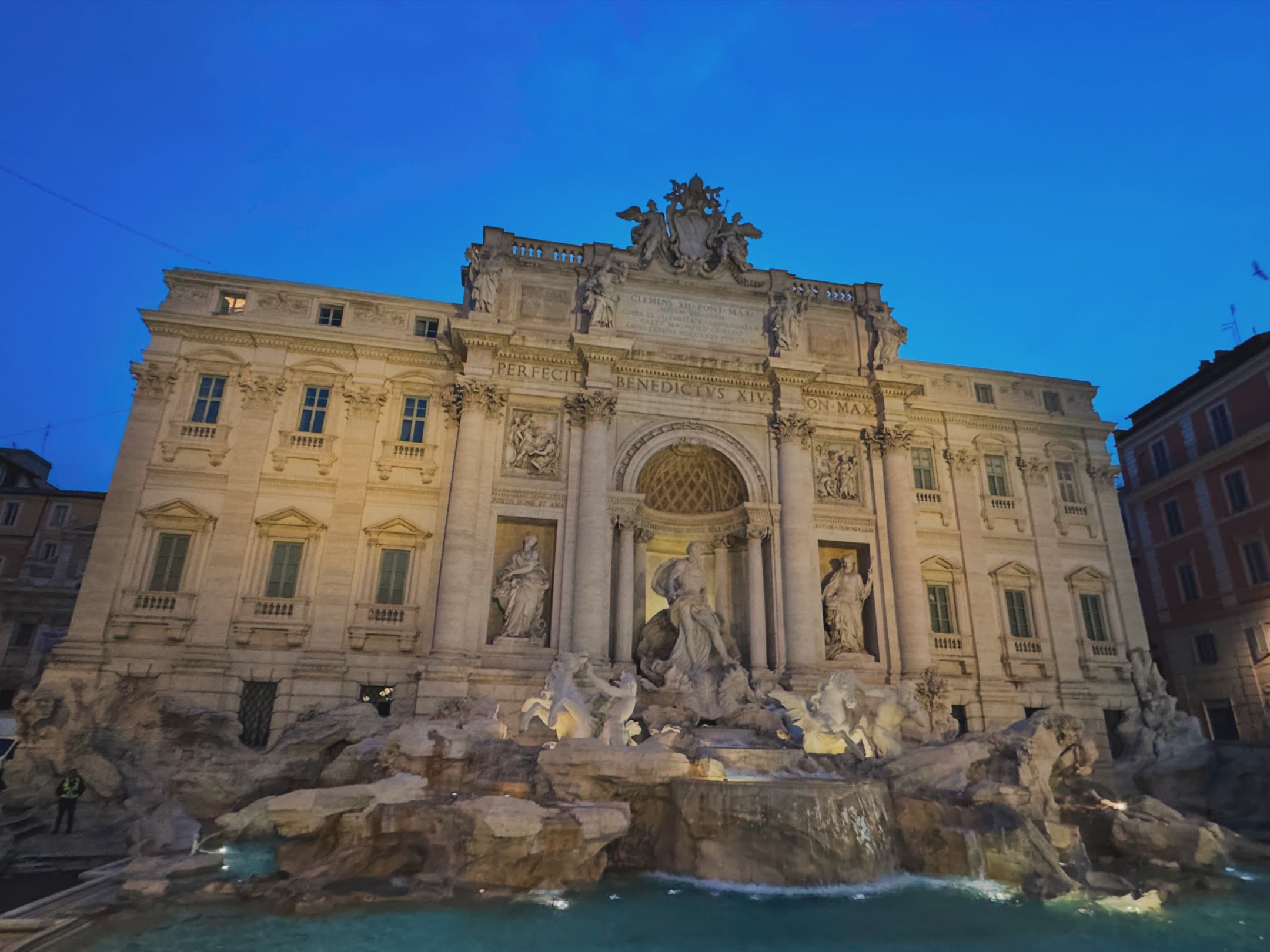 An image of a building in Italy lit up at nighttime.