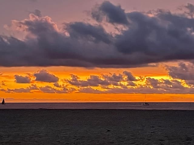 A vibrant orange and purple sunset over the ocean.