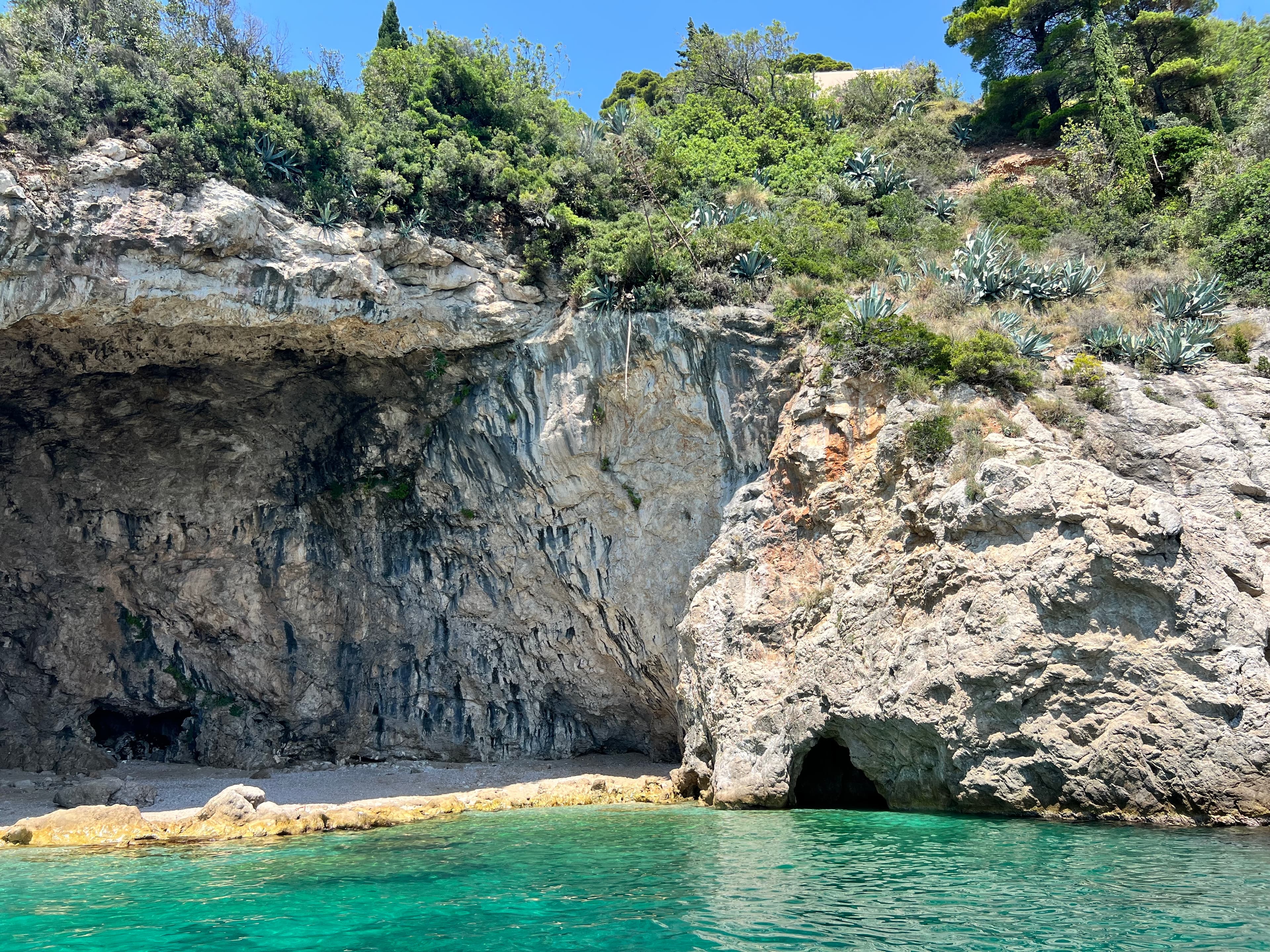 A view of turquoise blue water and rocky cliffs.