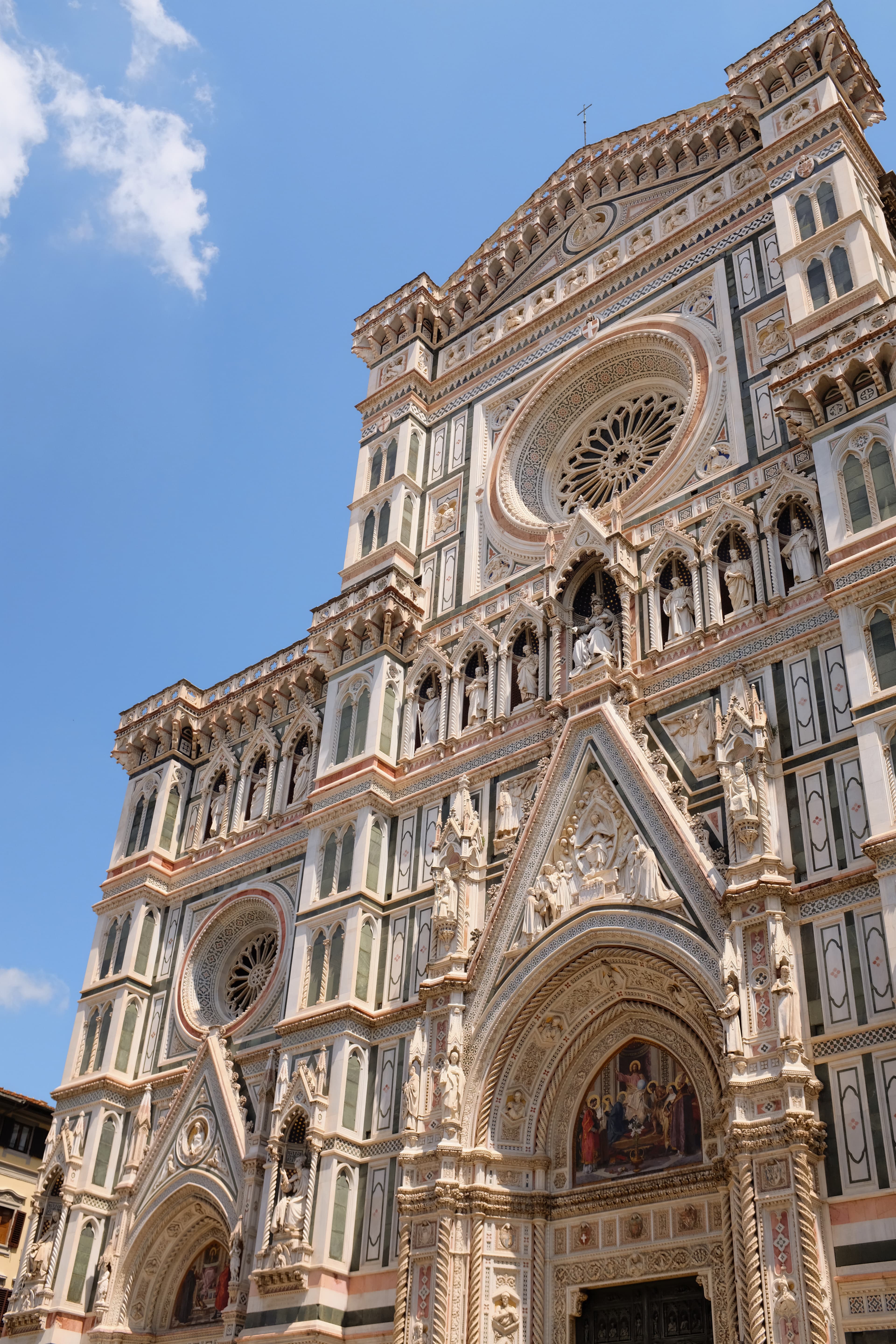 Cathedral rose windows glistens in the afternoon light on a sunny day.