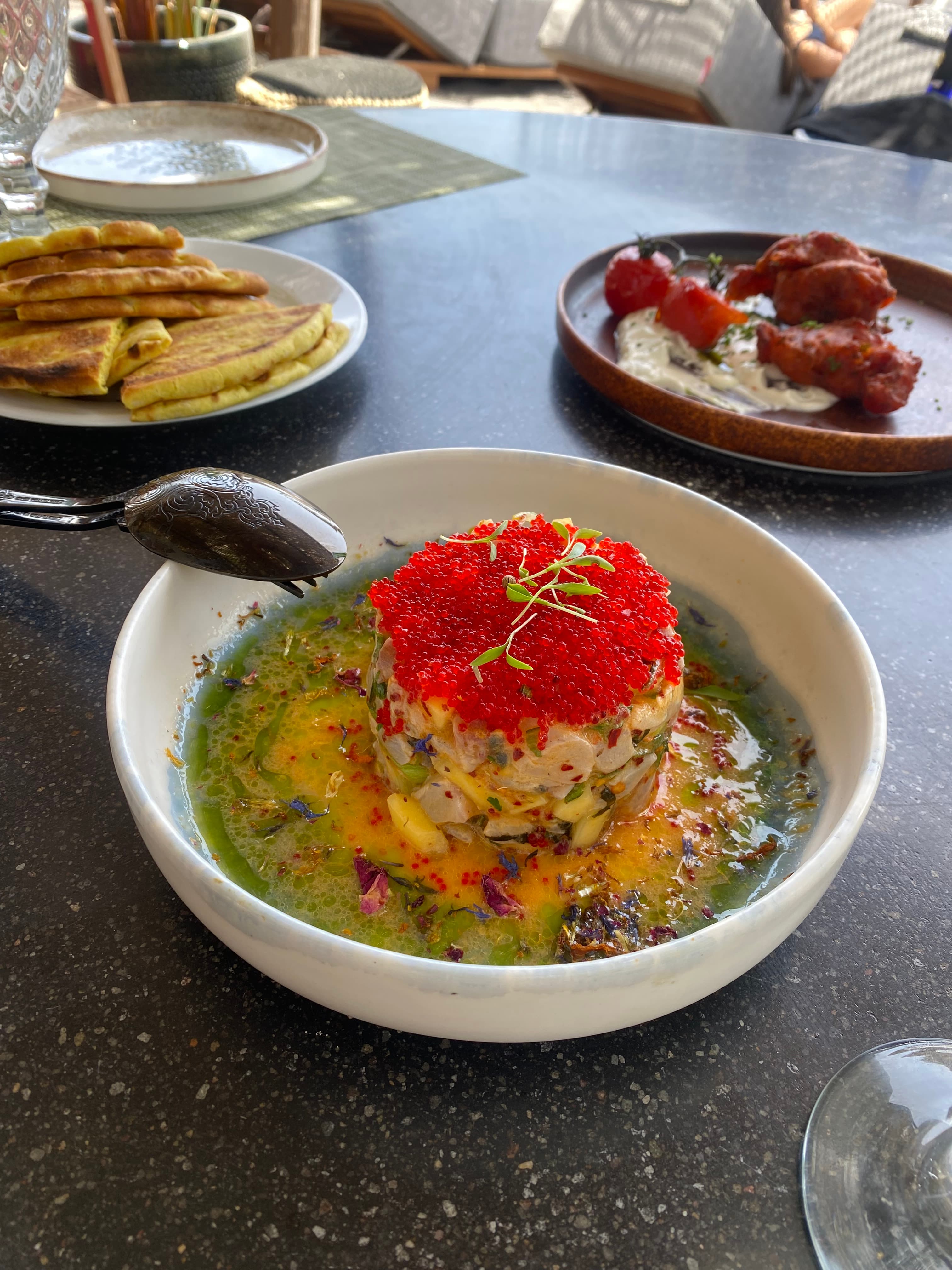 A delicately plated dish topped with caviar.
