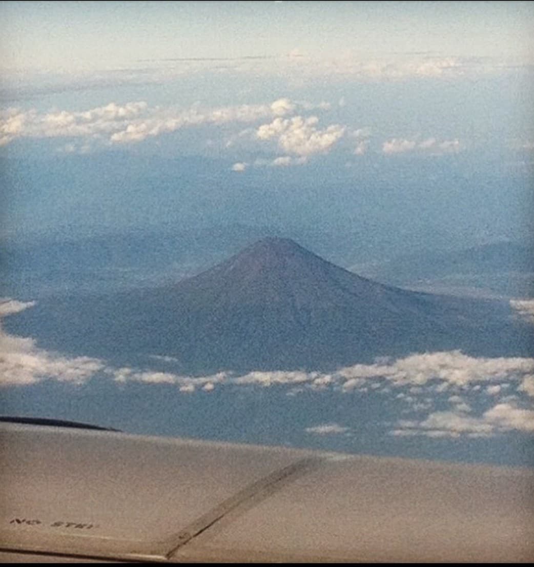 A aerial view of a mountain on a sunny day.