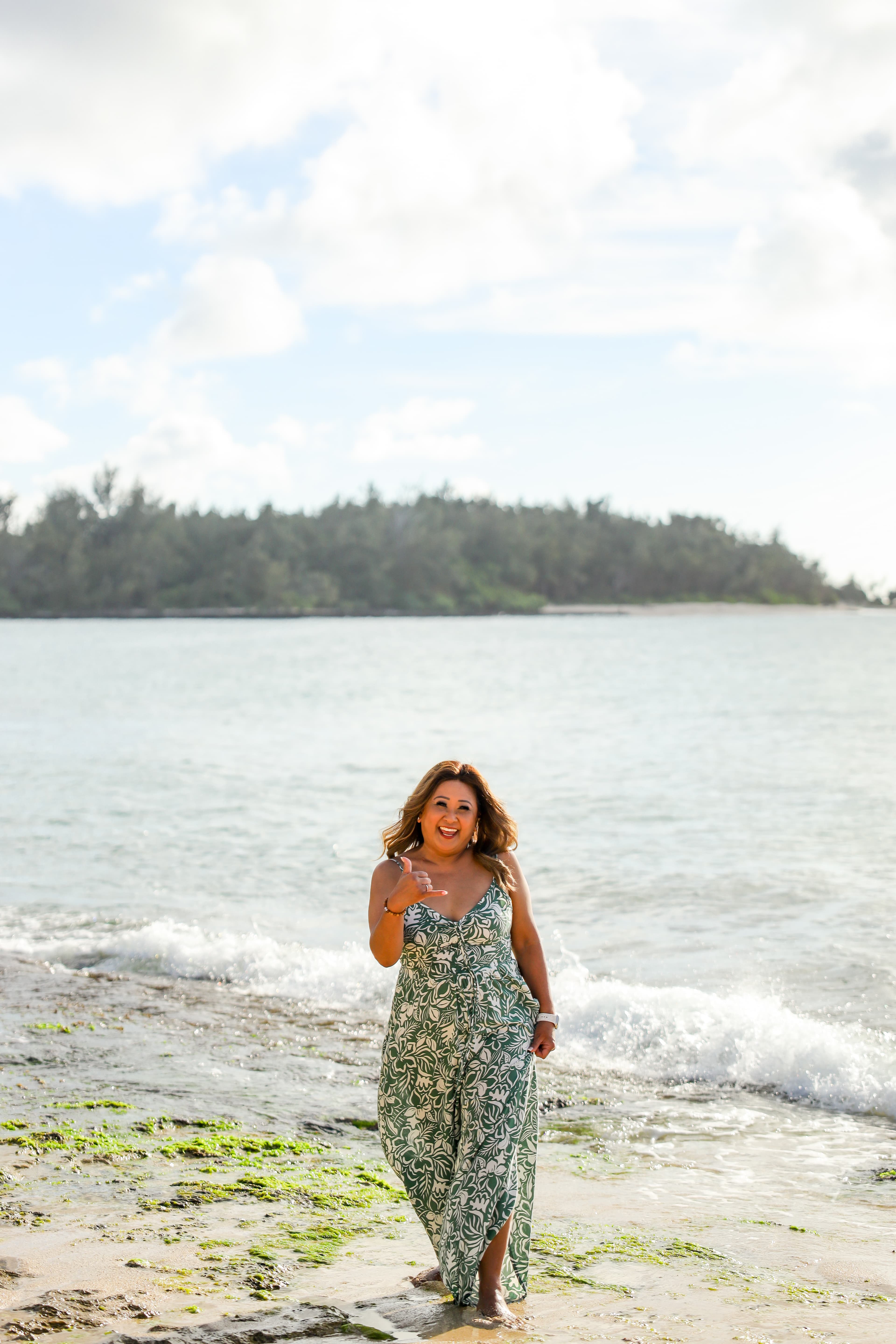 Advisor posing on a sandy beach on a sunny day.