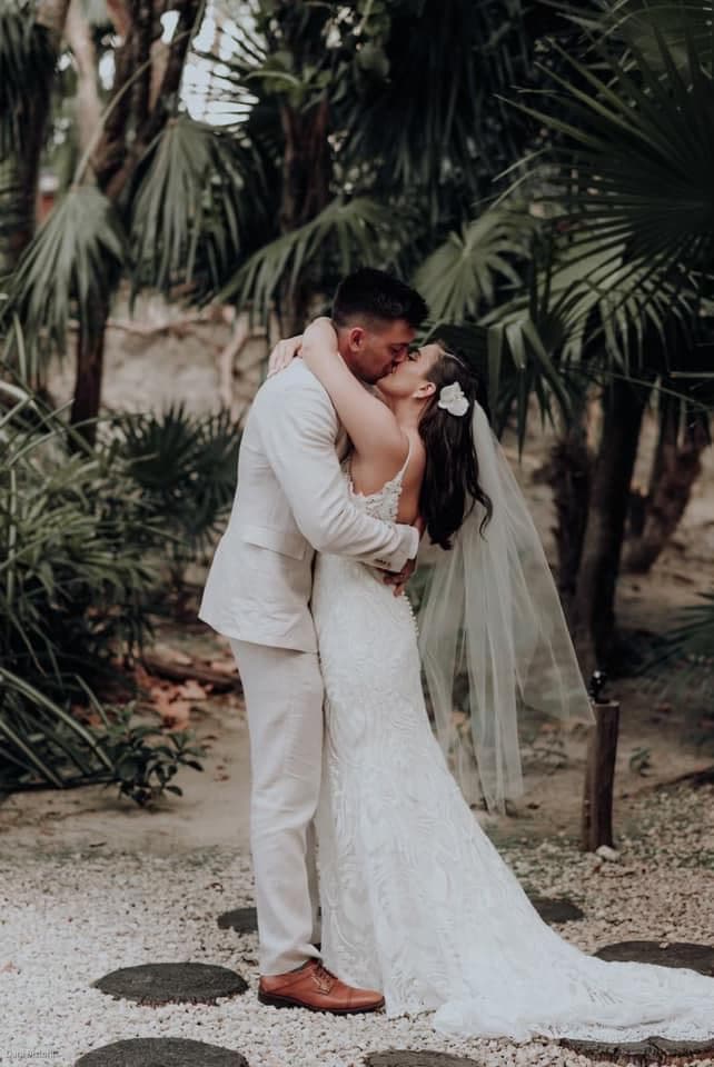 Advisor and her partner embracing outdoors on their wedding day