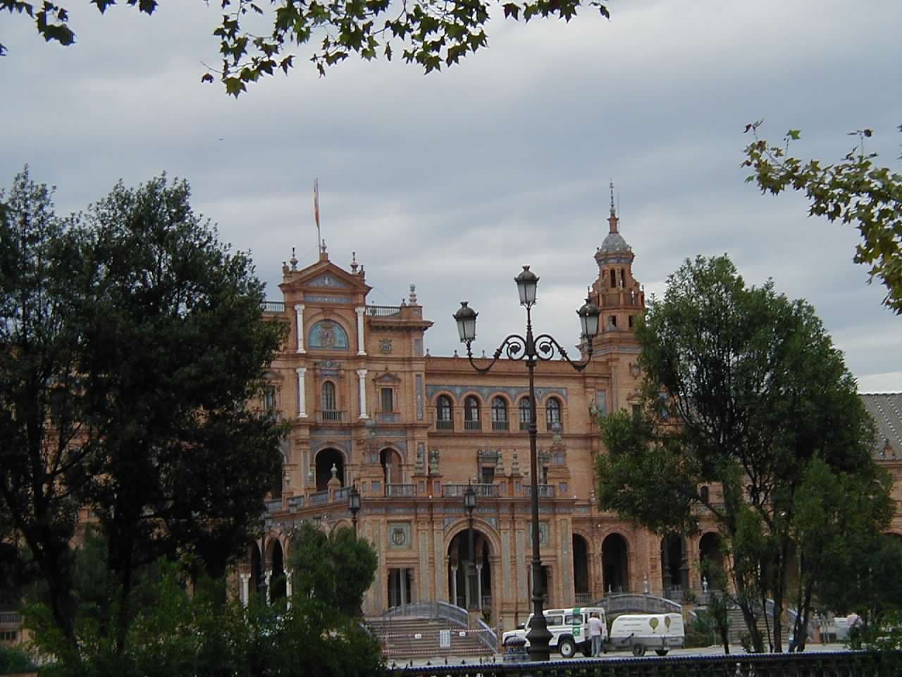 A view of a hotel in the distance with foliage.