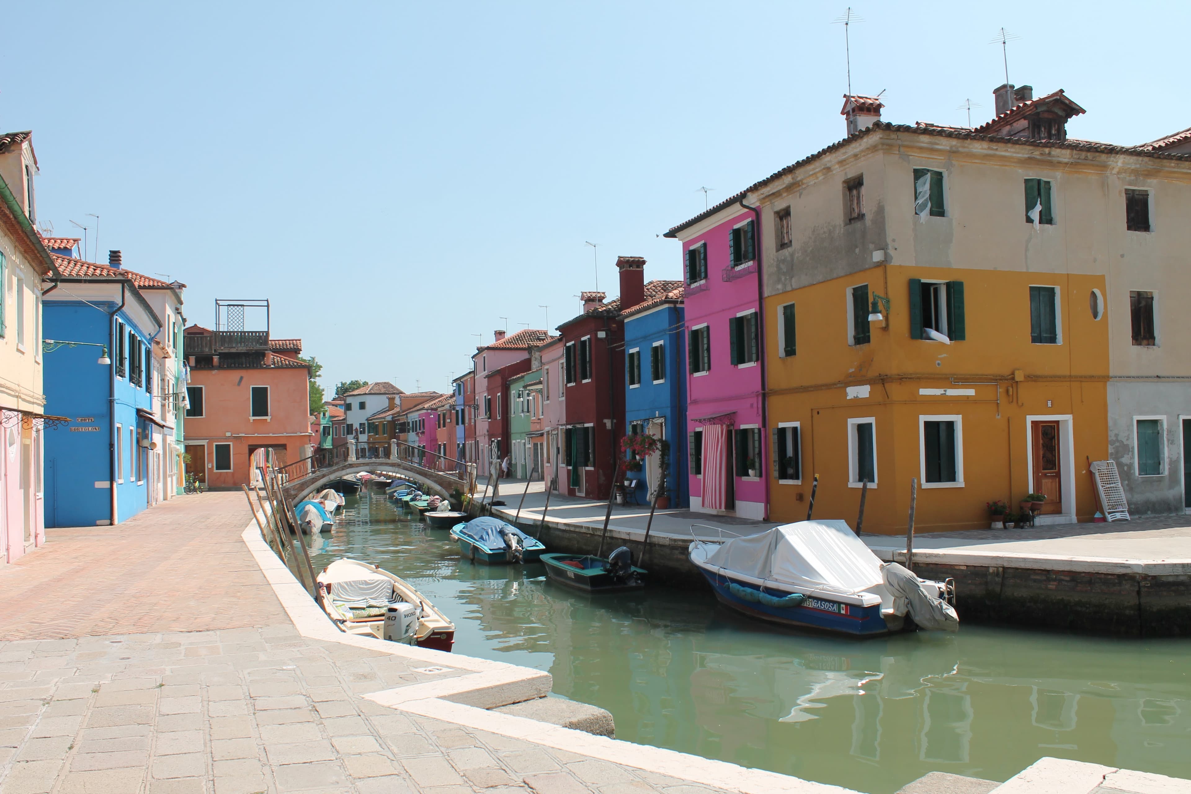 A view of a canal with colorful buildings during the daytime.