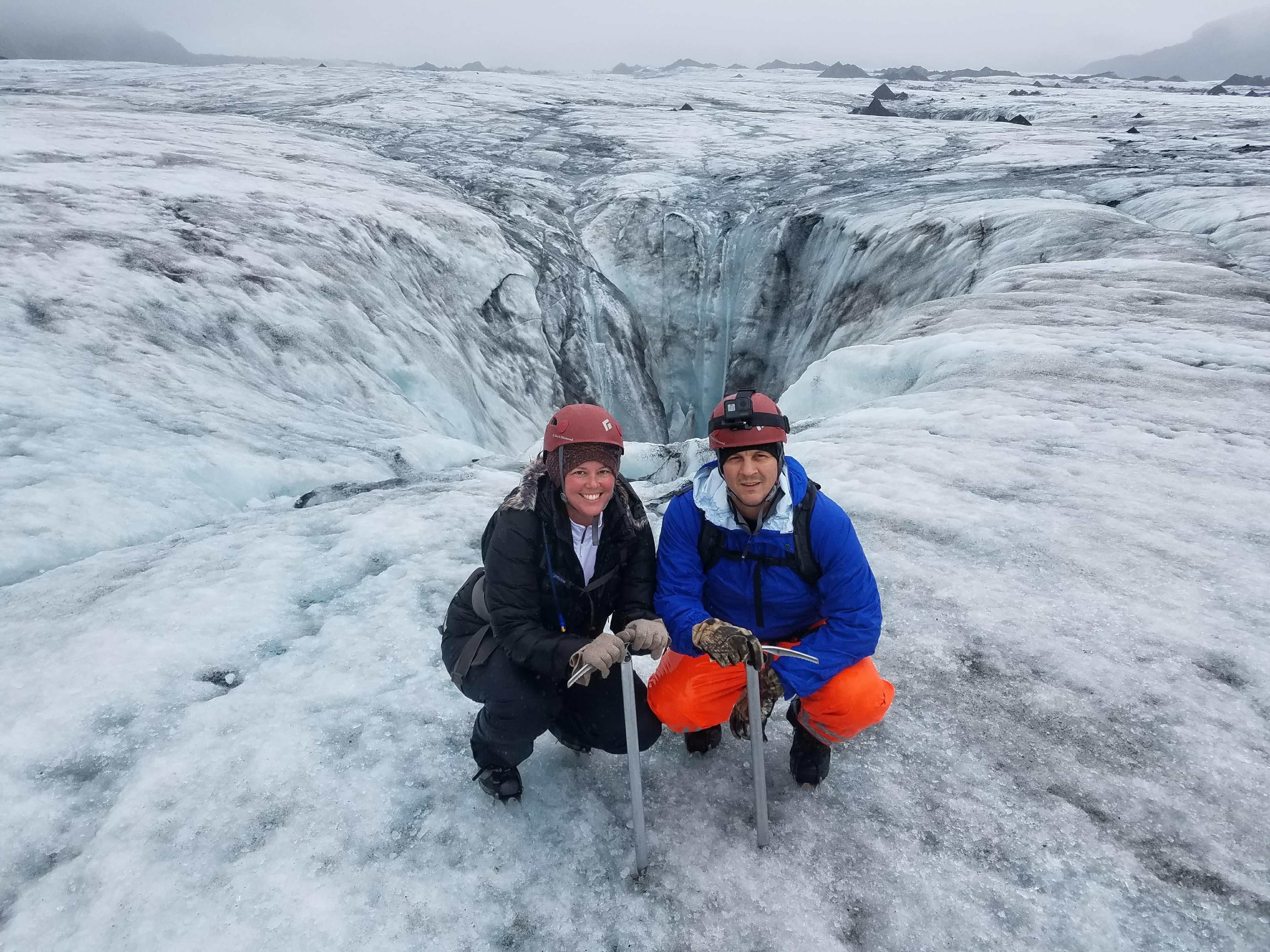 A couple posing for an image in a cold region.
