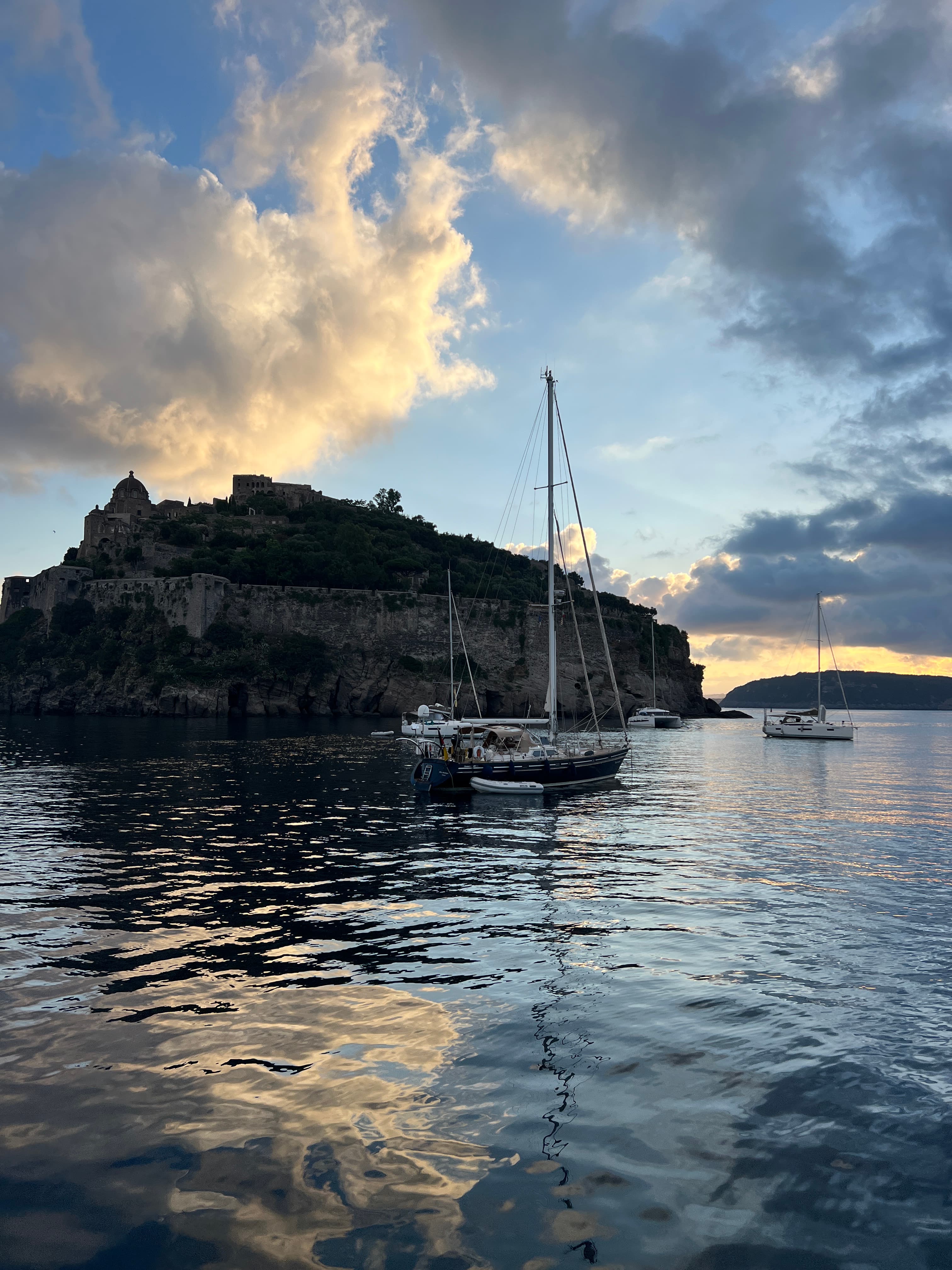 A view of a body of water with boats in it at dusk.