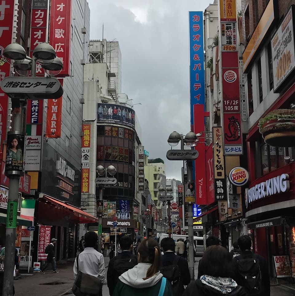 A view of a city with people during the daytime.