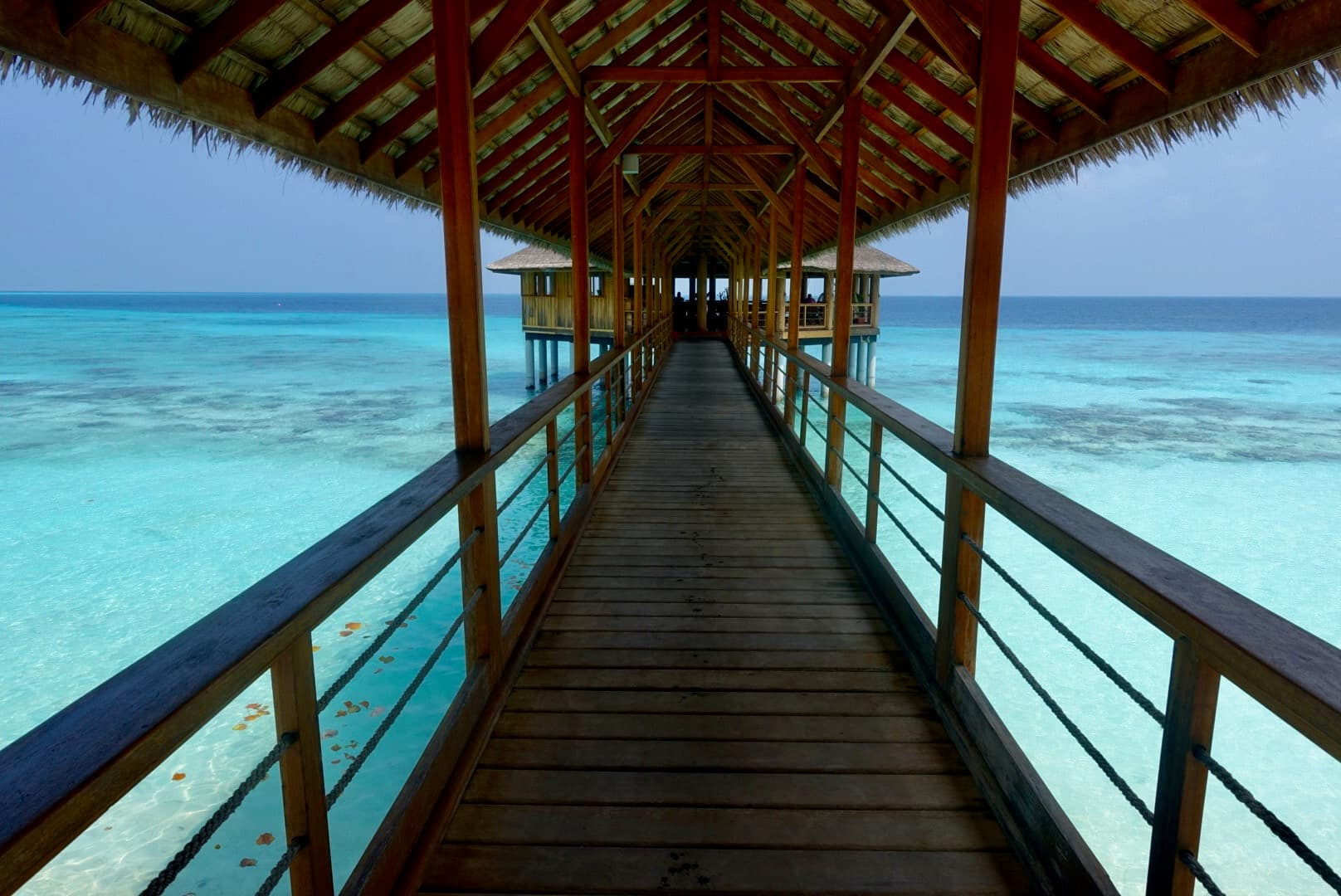 A walkway with the ocean in the distance.