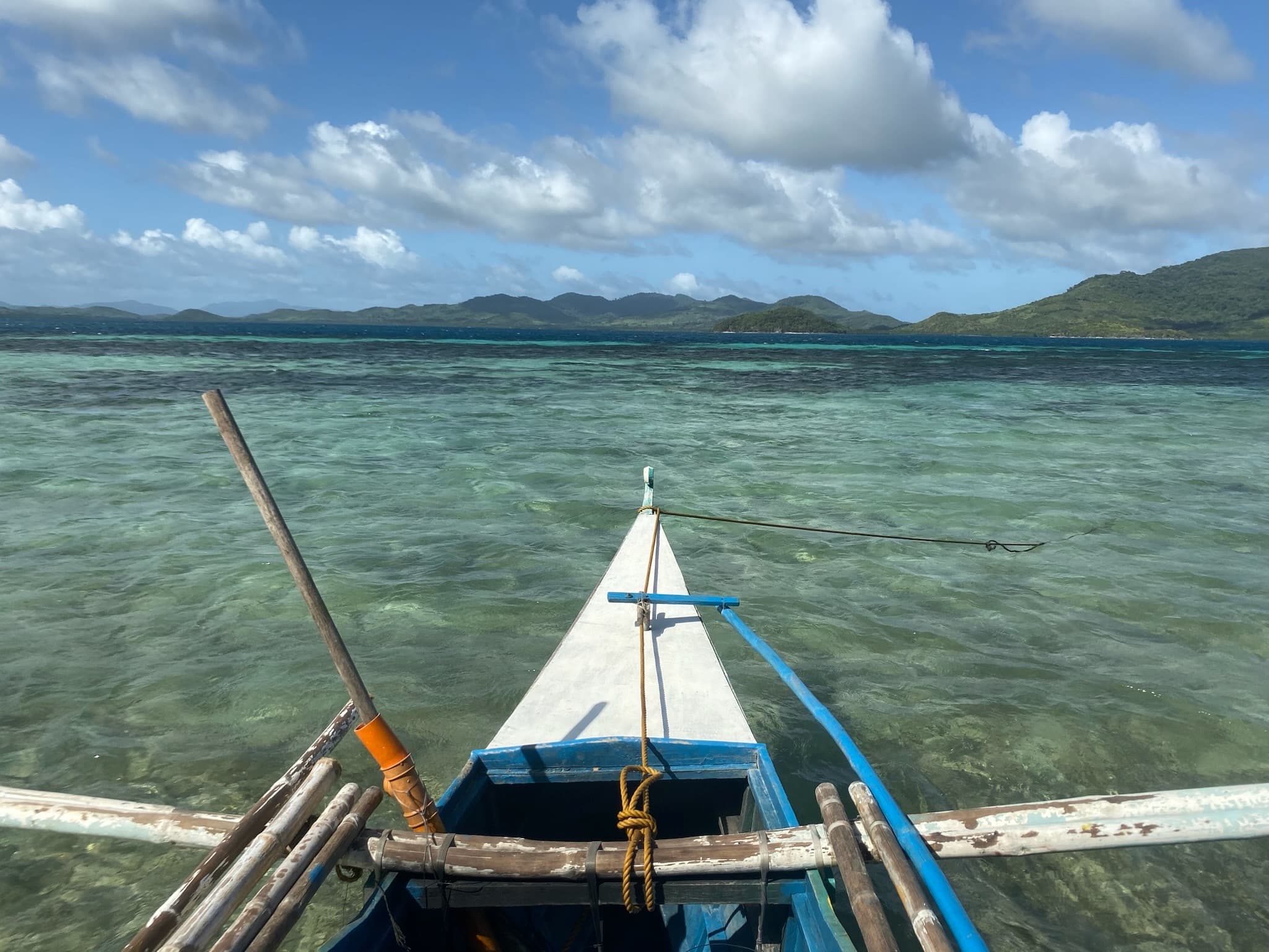 A view of the ocean with a boat in the water during the daytime.
