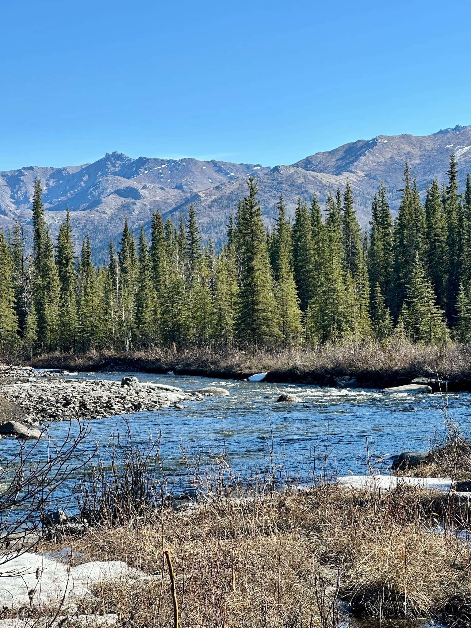 Beautiful view of a small river and distant mountain range on a clear day