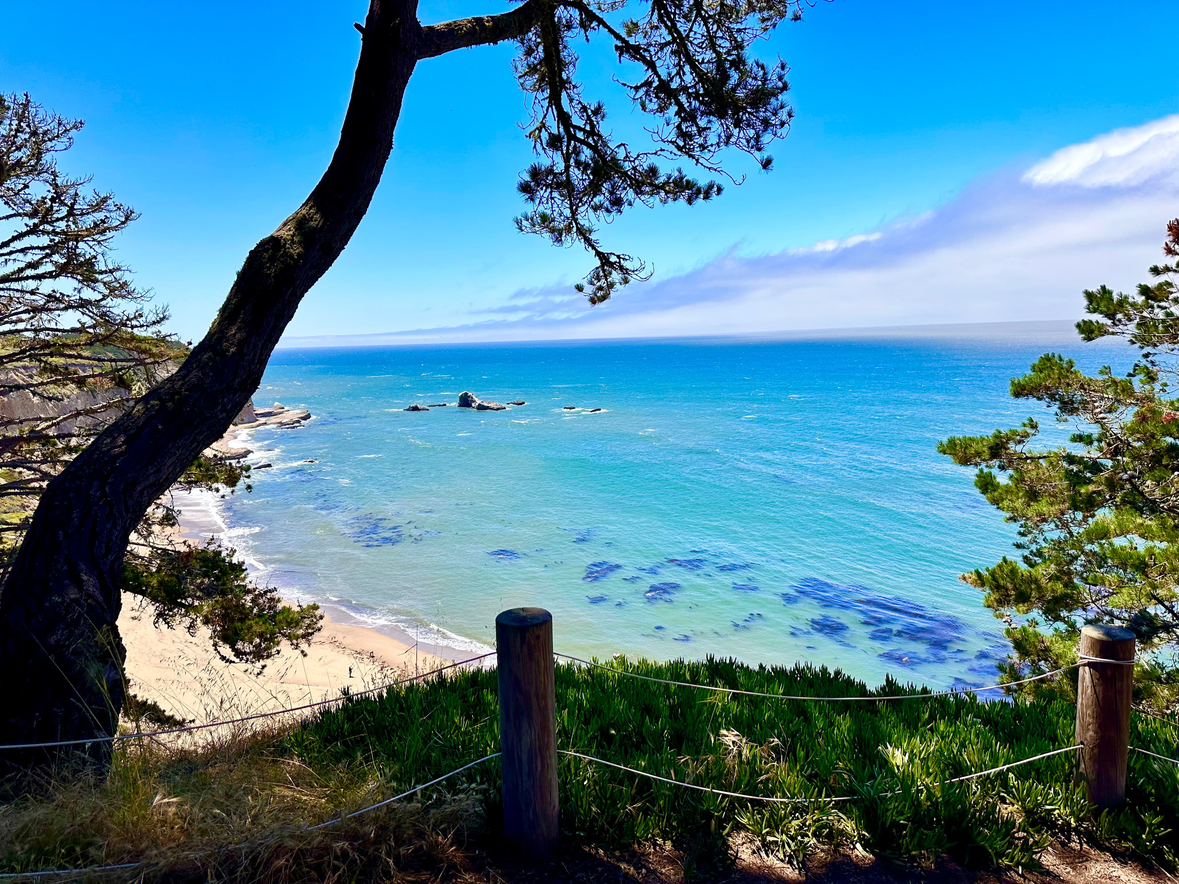 Viewpoint of a beautiful clear ocean and nearby beach on a sunny day