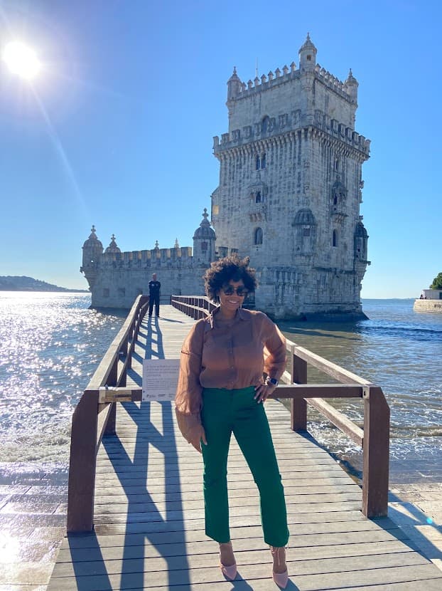 Advisor standing on a wooden pier extending to an old tower just offshore