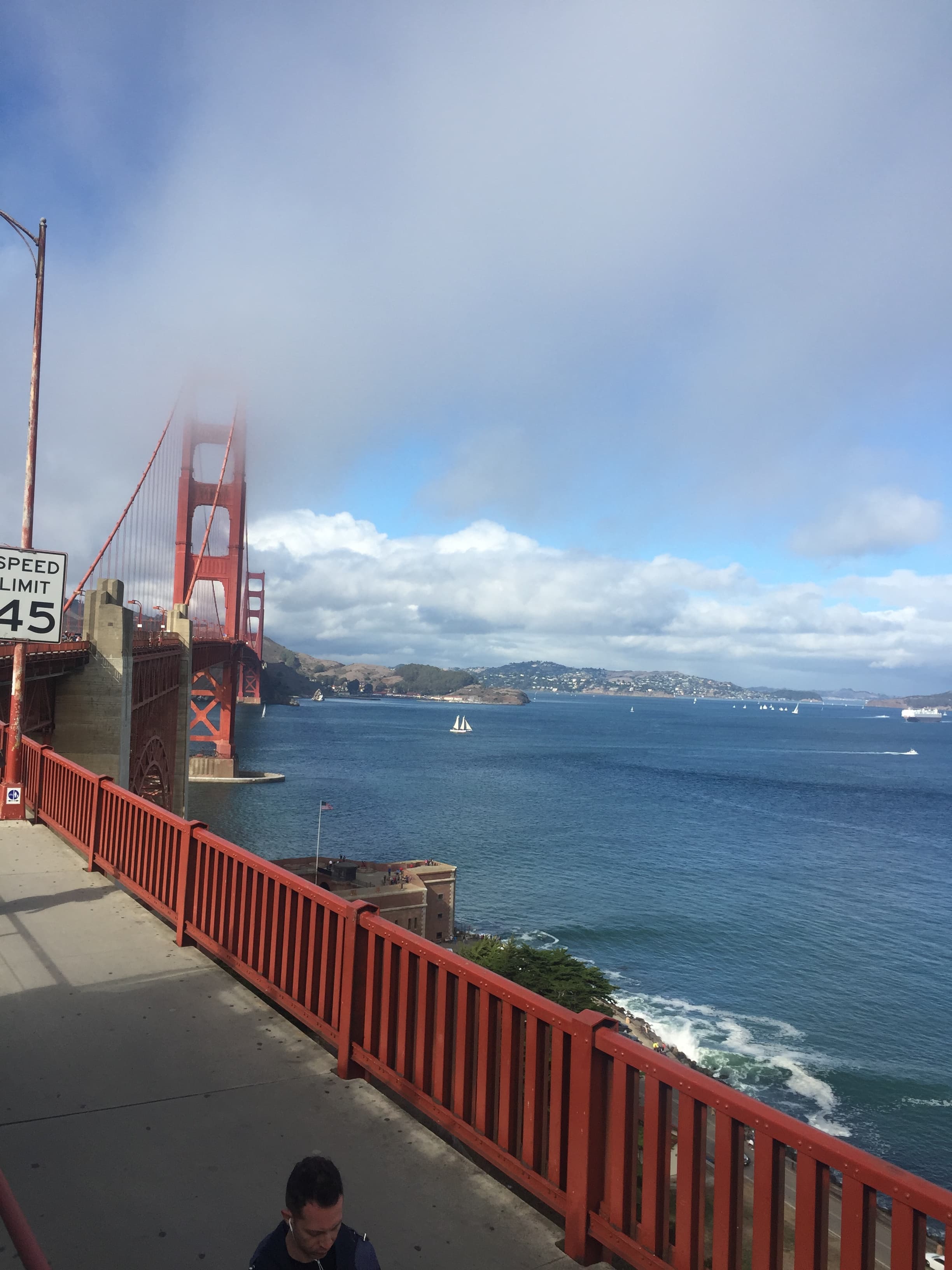 View of a bridge over a body of water during the daytime.