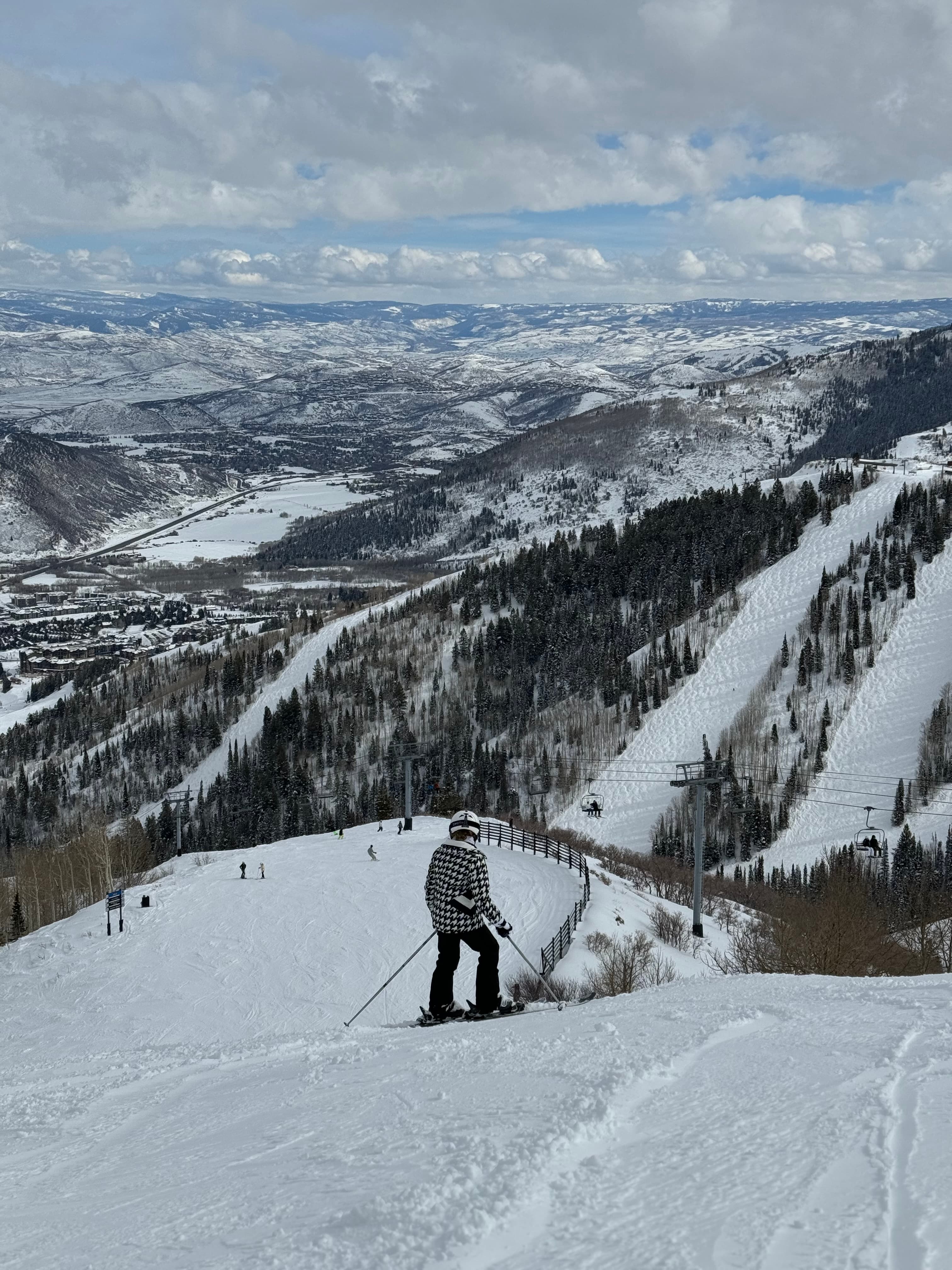 View of a person skiing down a large mountain