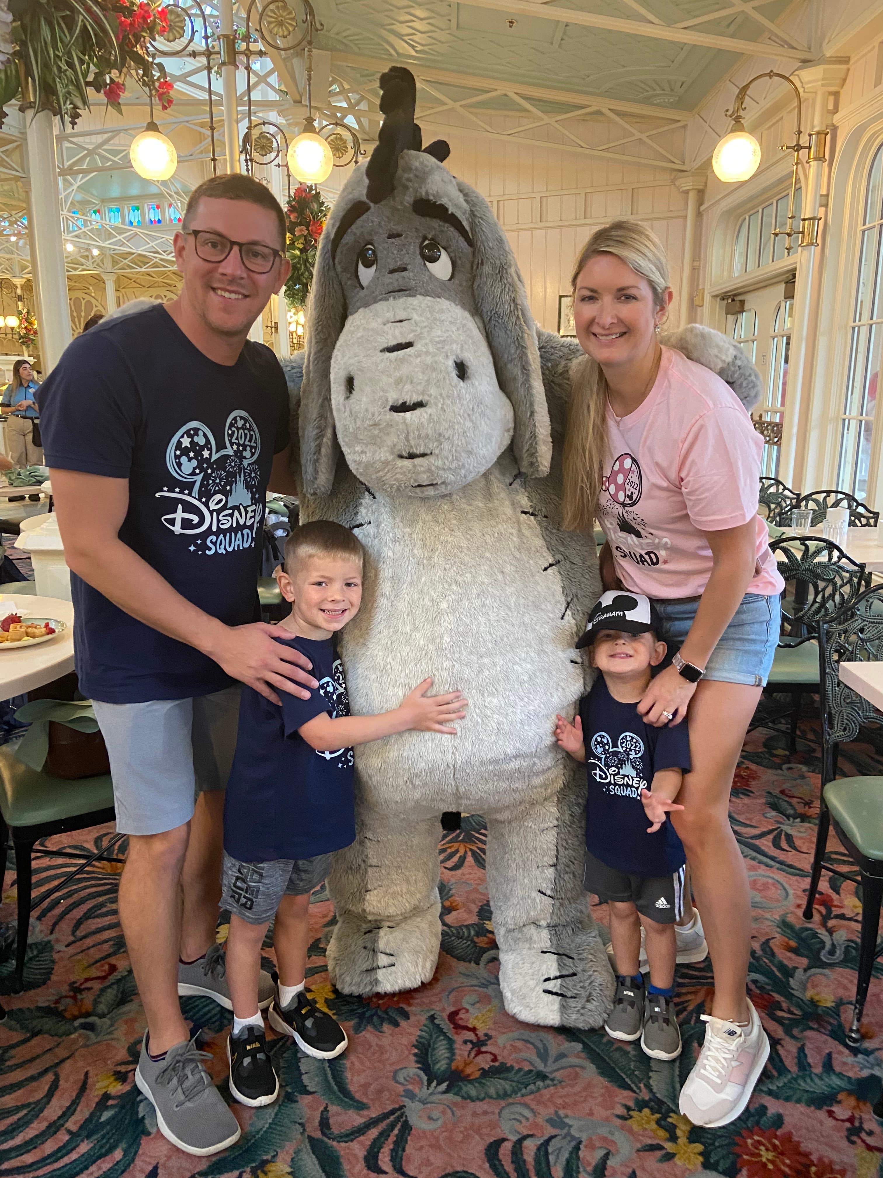 Advisor and family posing with a person in a donkey costume