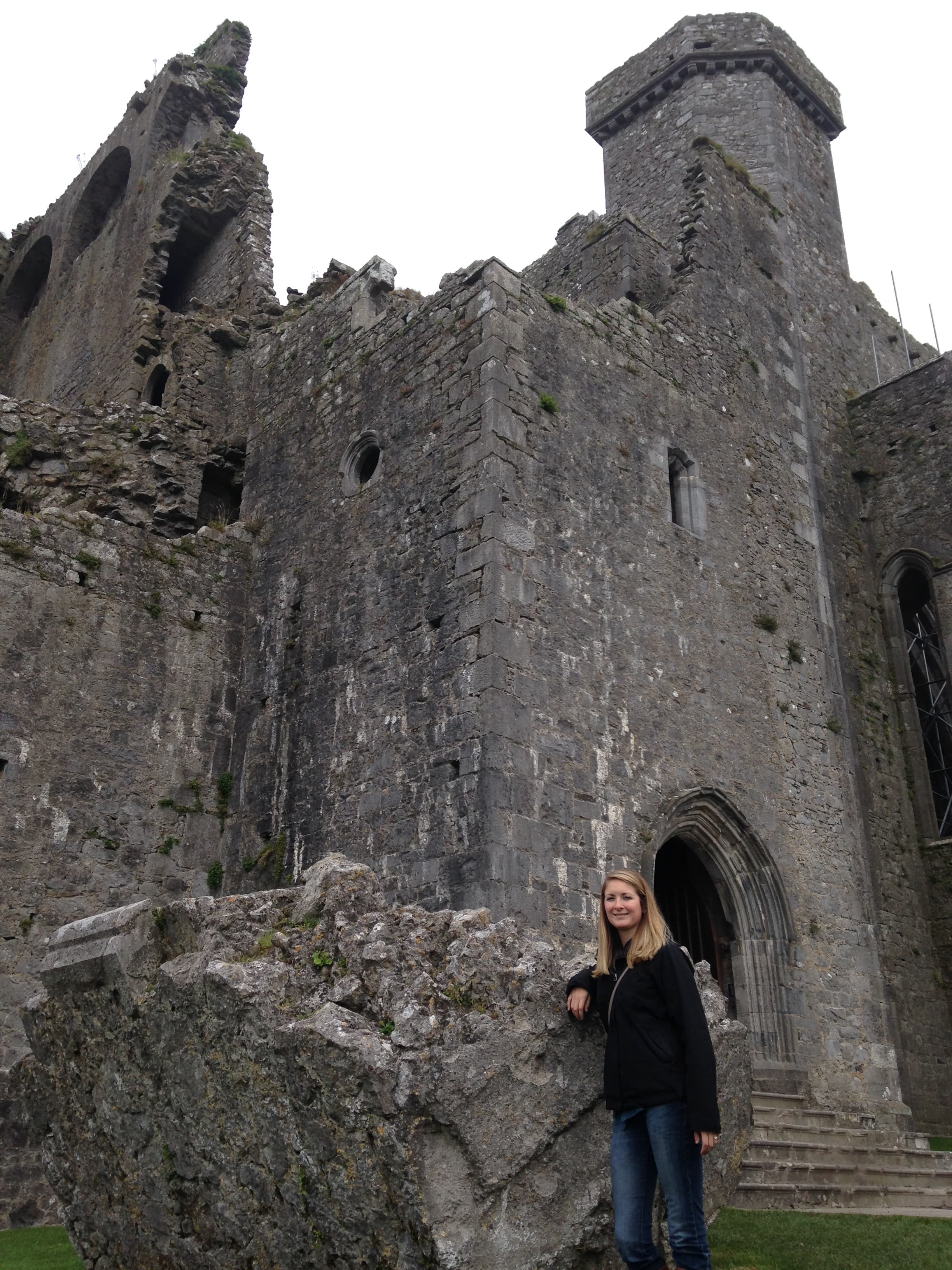 Advisor standing on the steps of an old castle on a cloudy day