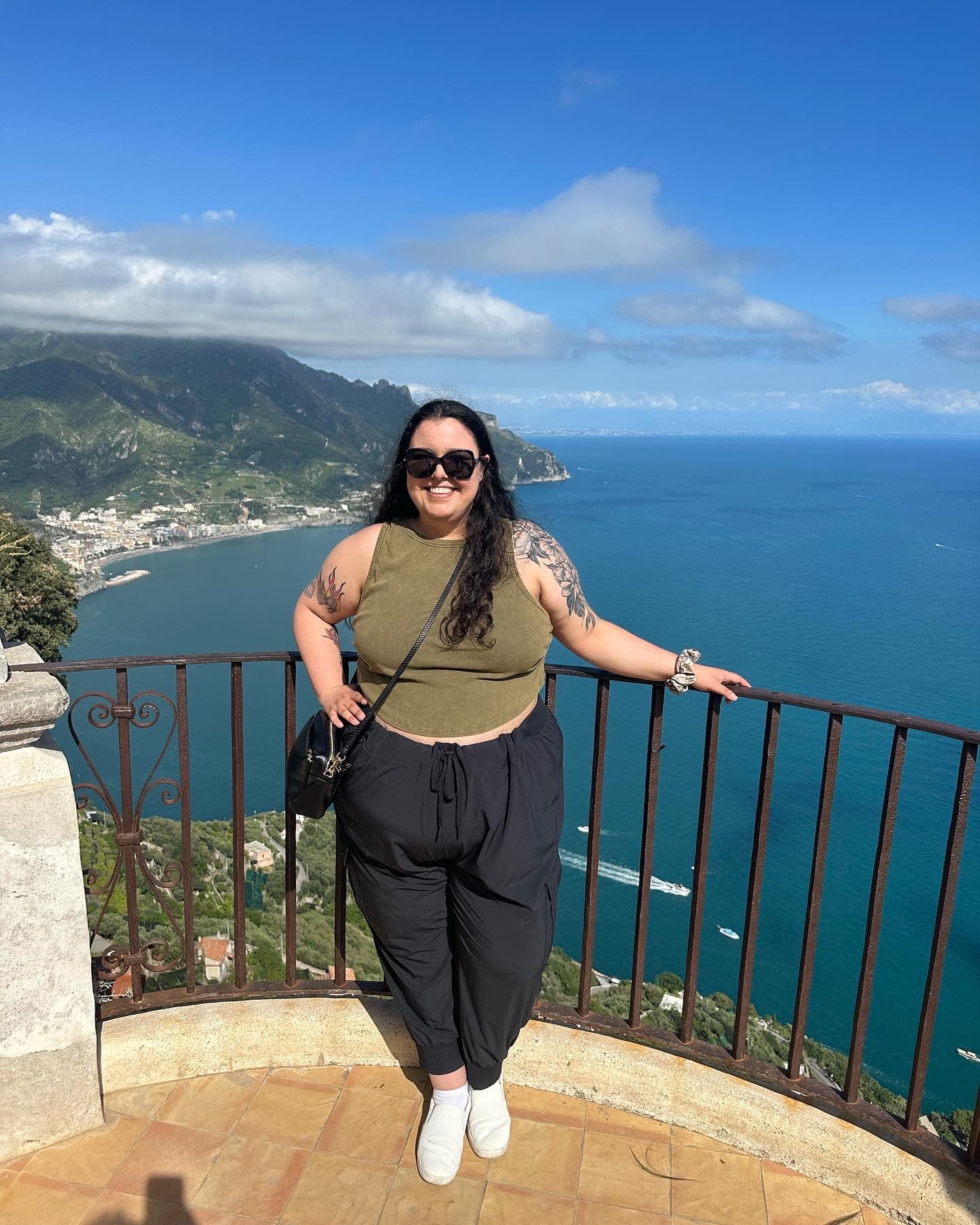 Advisor posing at a viewpoint overlooking the sea and coast on a sunny day