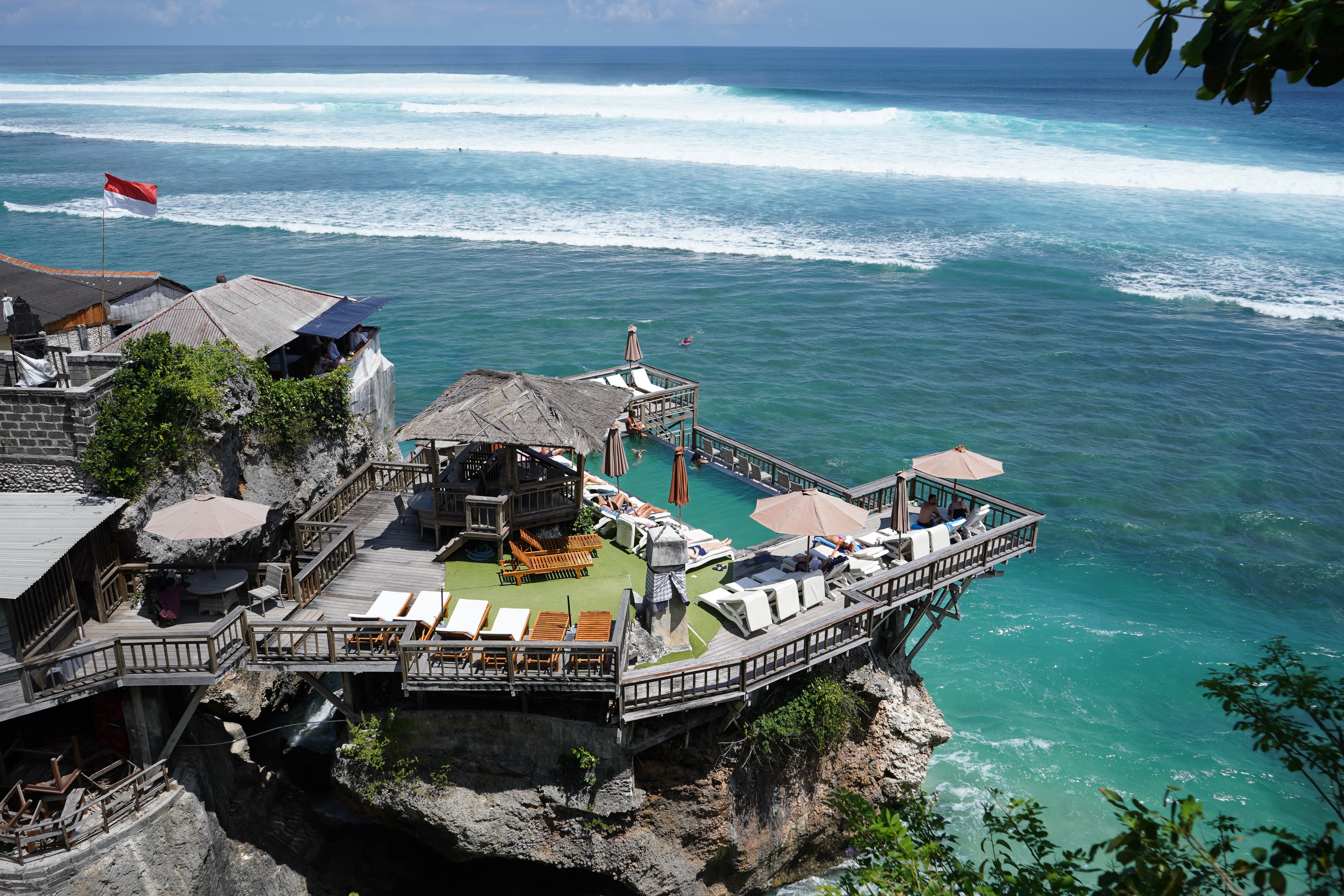 Aerial view of an oceanside resort overlooking a surf break