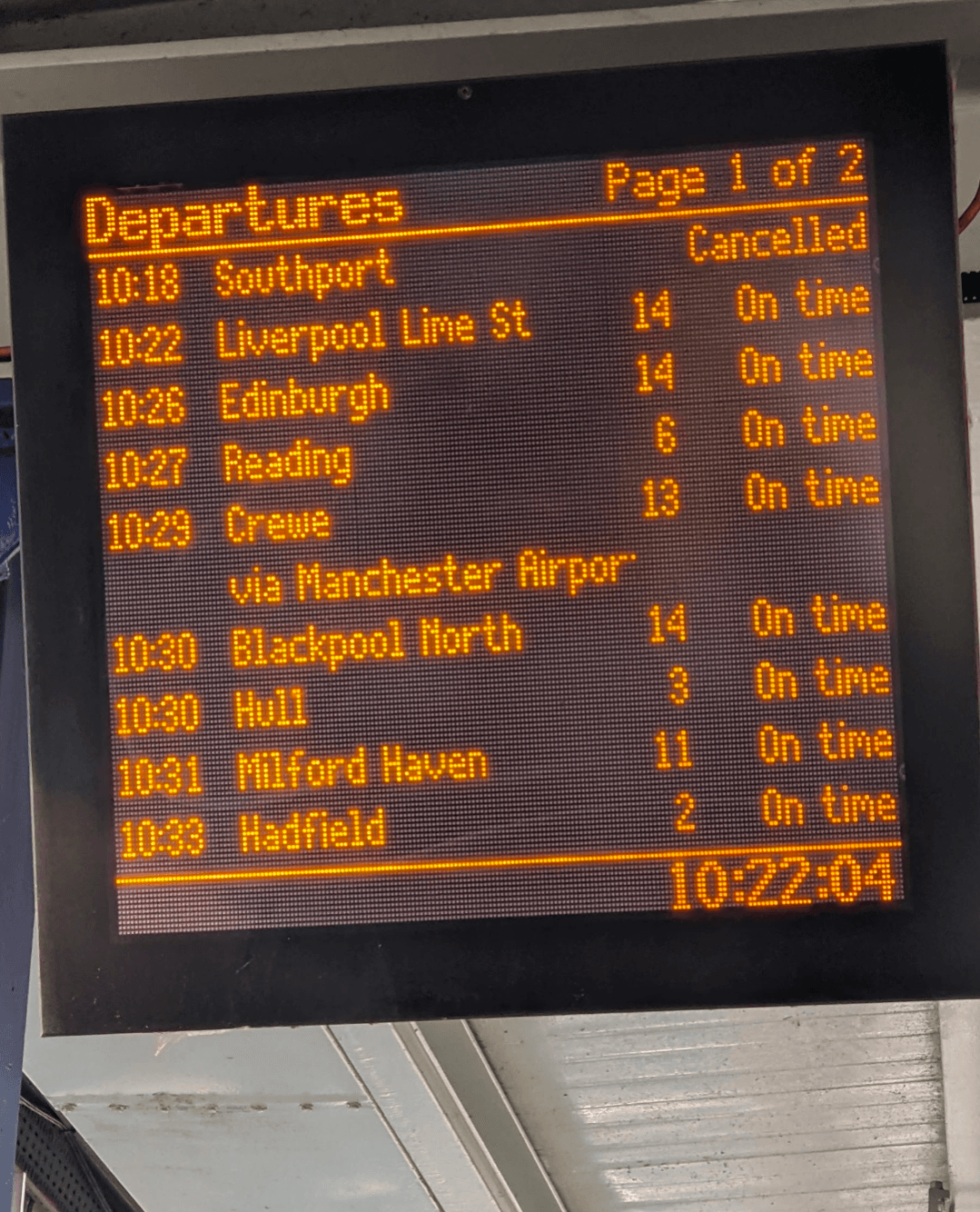 A train departure board featuring the scheduled times for various lines, prominently displayed in a transit hub.