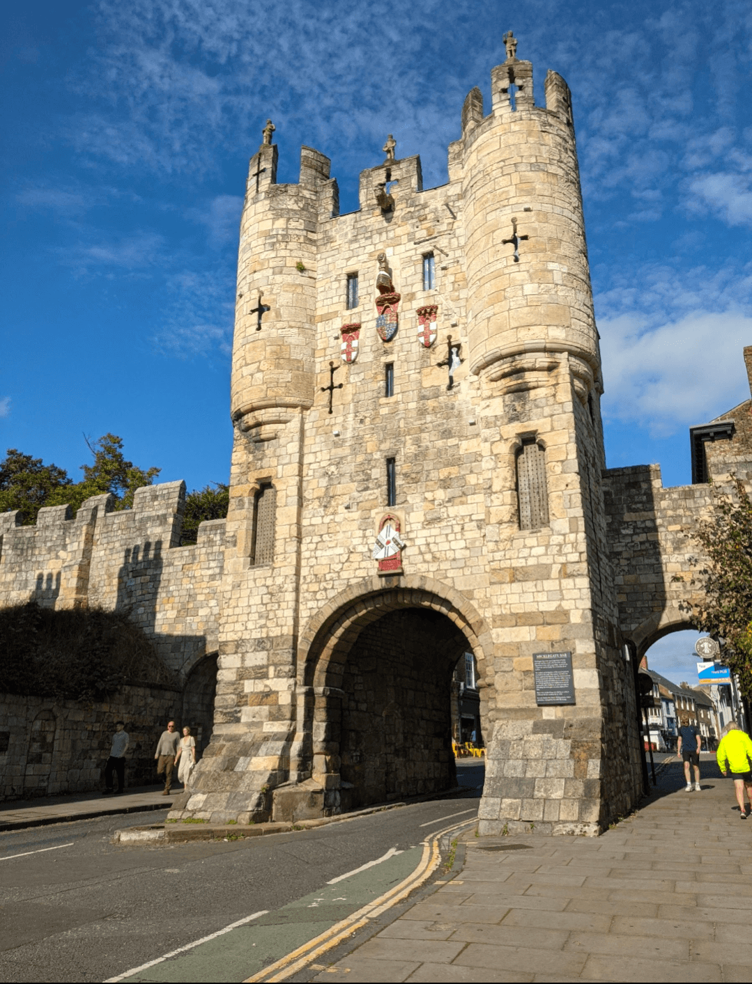 The historic entrance to the old city of York, showcasing ancient stone walls and a charming archway.