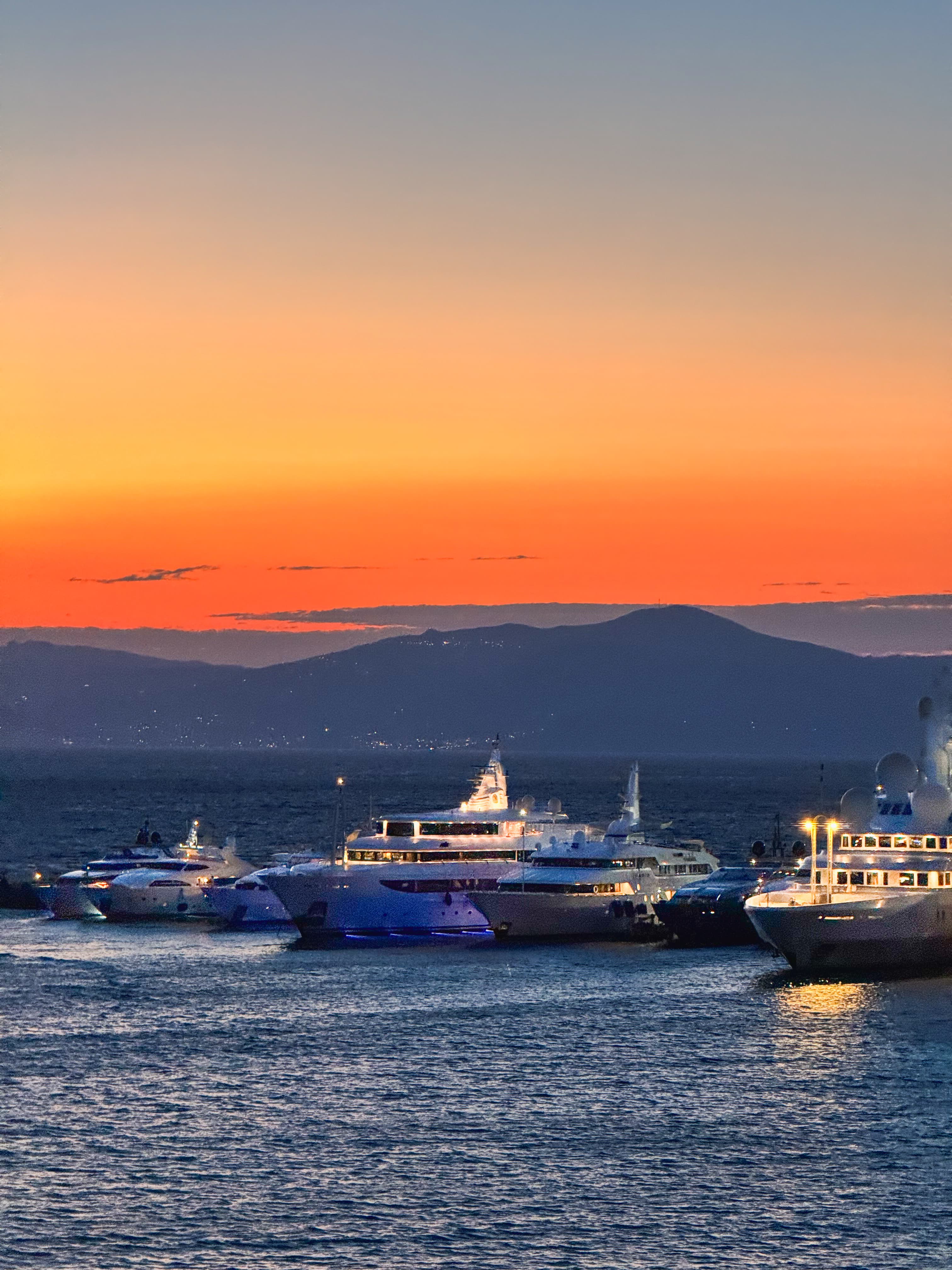 Beautiful view of yachts in a marina under an orange sunset