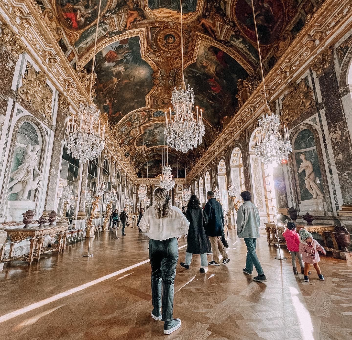 Advisor walking through a hall in the Louvre Museum on a sunny day